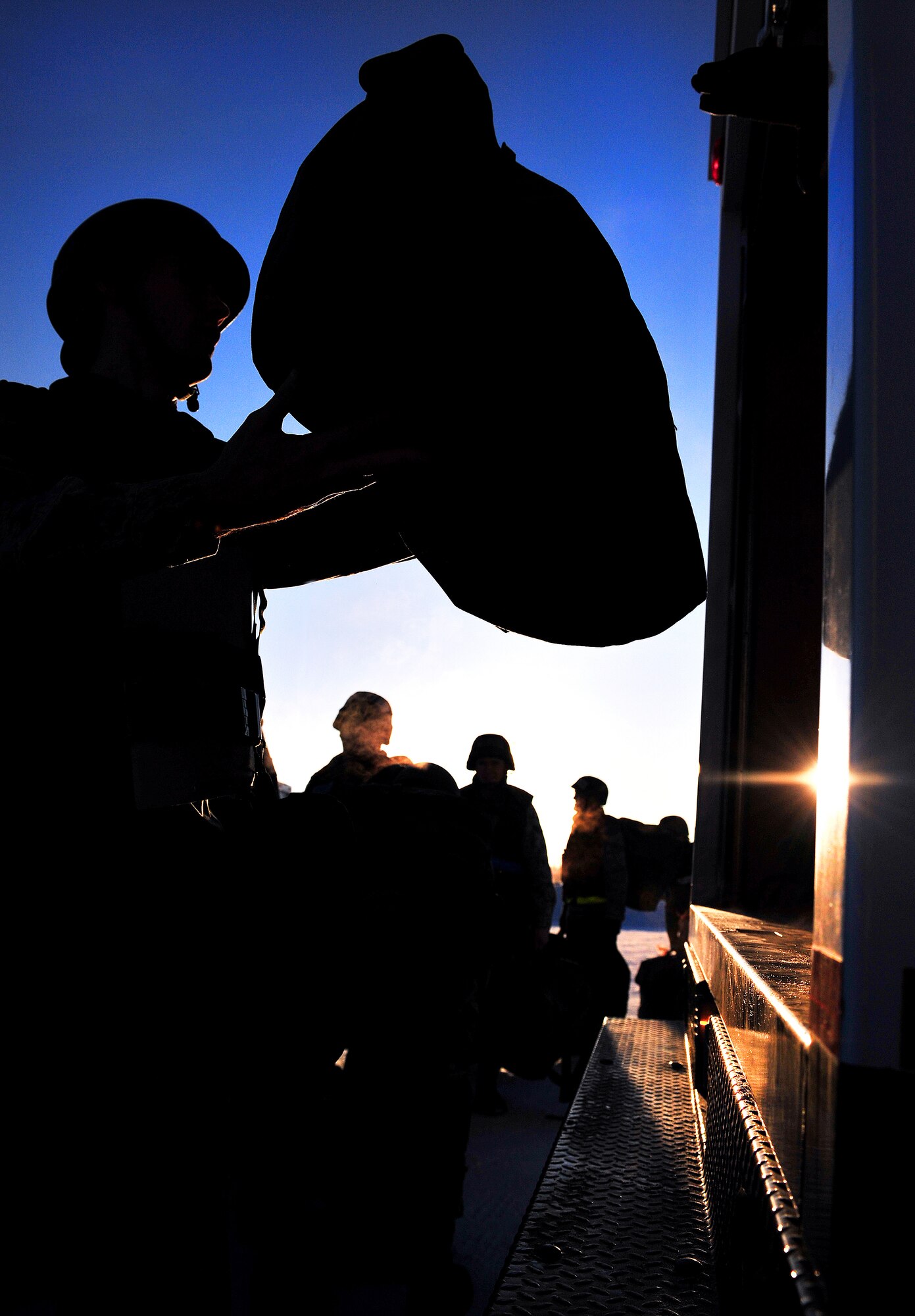 An Airman from the 354th Fighter Wing loads his bag onto a vehicle Feb. 11, 2009 at Eielson Air Force Base, Alaska. The vehicle will be going to the Joint Mobility Center where Airmen will make last minute preparations for a mock deployment. The process Airmen undergo at the JMC is nearly identical to that as if they were actually deploying. (U.S. Air Force photo/ Airman 1st Class Willard E. Grande II)