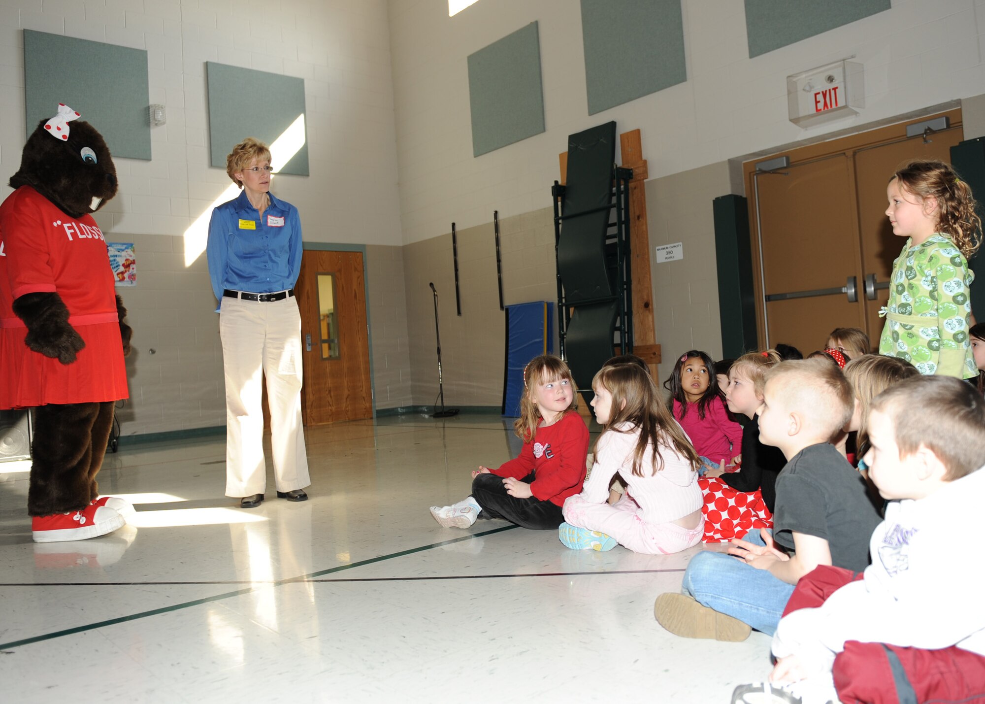 SCOTT AIR FORCE BASE, Ill. -- Flossy the Beaver and Virginia Bennett, both from the 375th Dental Squadron, talk with students about National Children's Dental Health Month at Scott Elementary. Ms. Bennett talked about the importance of visiting the dentist, flossing, brushing and proper diet to maintain good oral hygiene. (U.S. Air Force photo/Staff Sgt. Paul Villanueva)