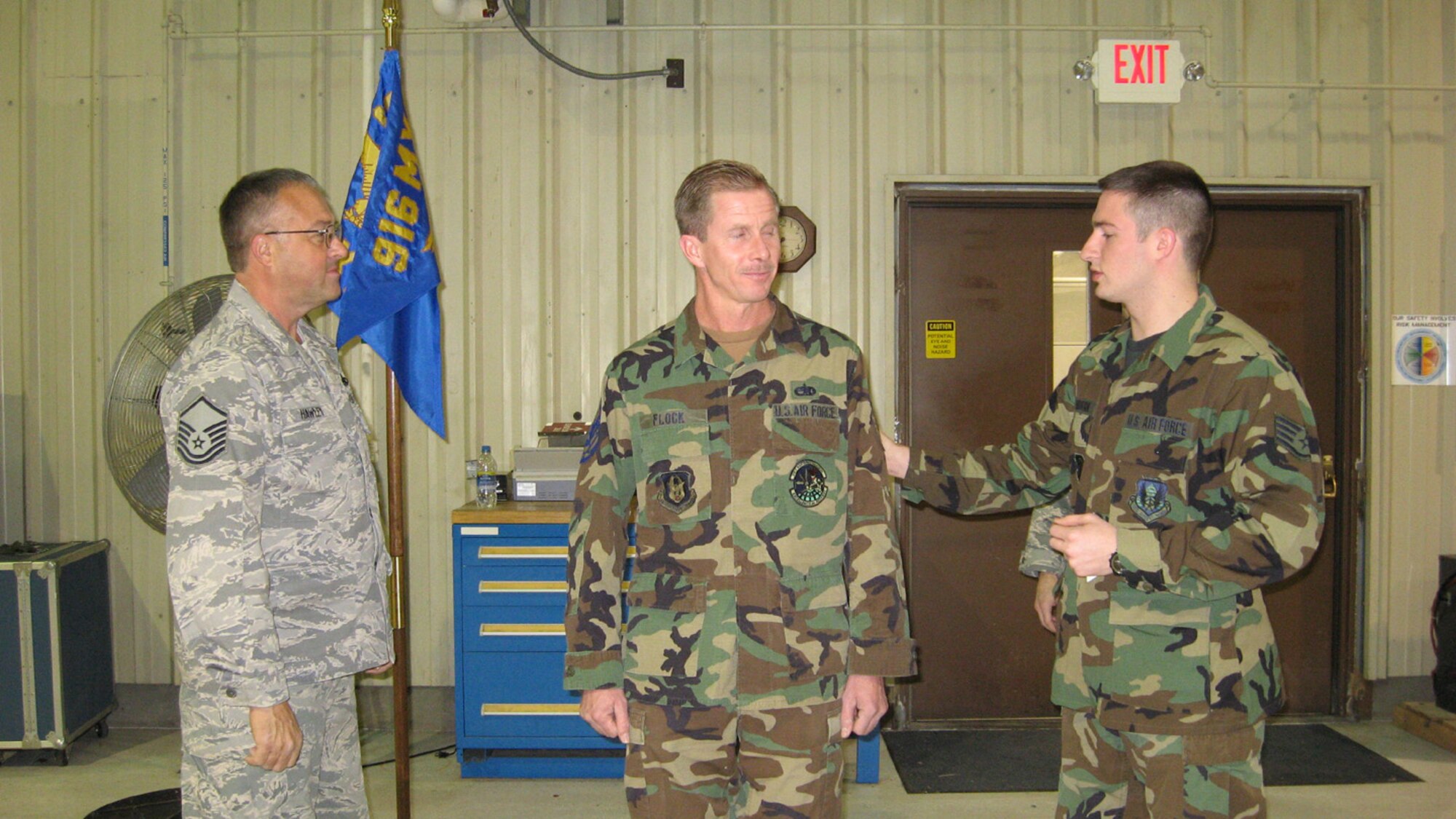 SEYMOUR JOHNSON AIR FORCE BASE, N.C. -- Reservist Michael Flock (center) is promoted to the rank of technical sergeant during the January unit training assembly. Promoting Sgt. Flock is Master Sgt. Steve Hawley and Staff Sgt. Jason Manookian. All are assigned to the 916th Air Refueling Wing Maintenance Group.