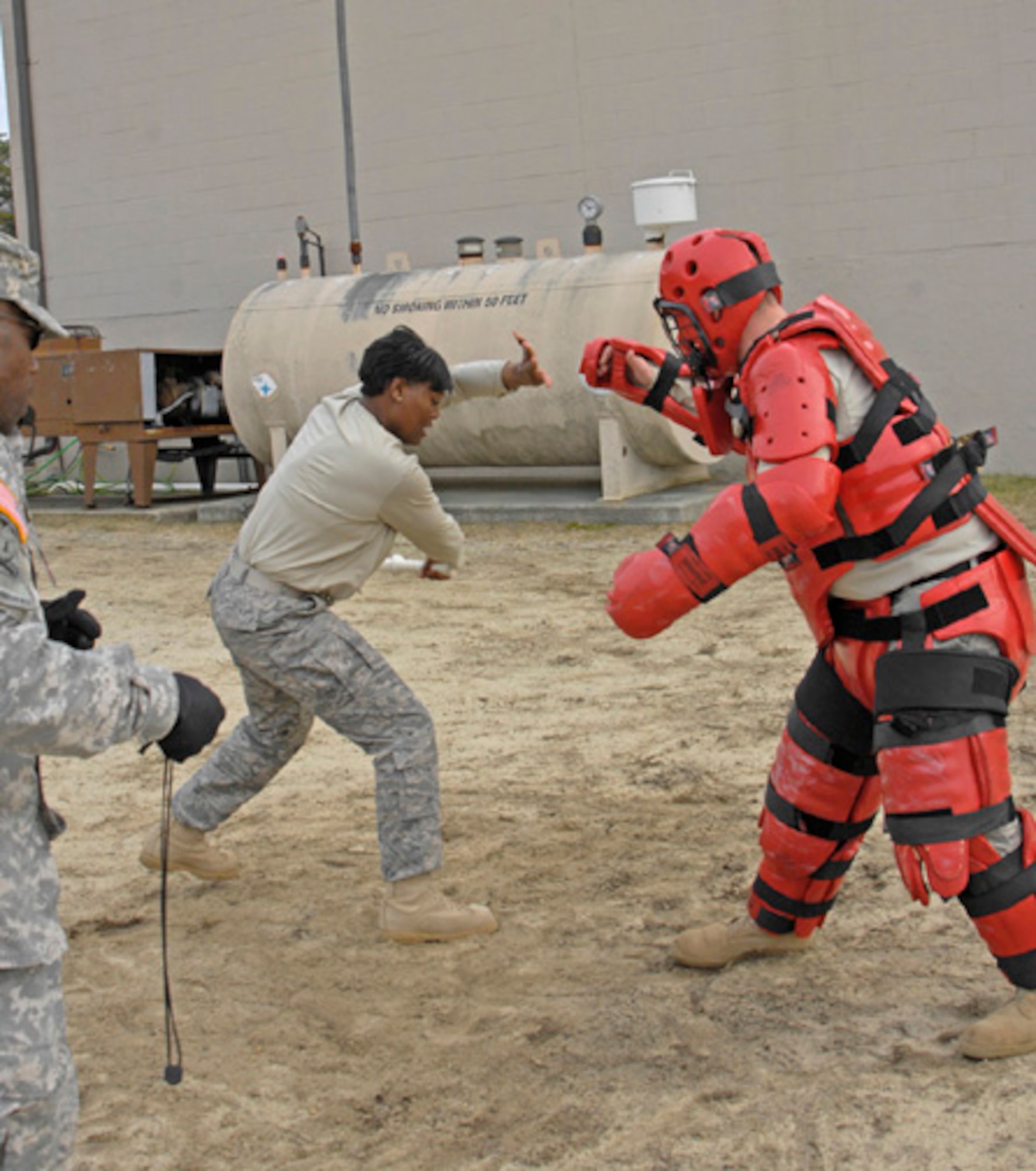 Capt. Donna Porter-Simmons, commander of the Air Force Alpha 6 squadron, works her way through a training session after being sprayed with OC spray, a spray used in self-defense training at the Detainee Operations compound. Captain Porter-Simmons and the rest of her command learned how to continue fighting when they could not see and with their eyes burning and noses running from the effects of the spray. (U.S. Army photo/Lisa Evans) 