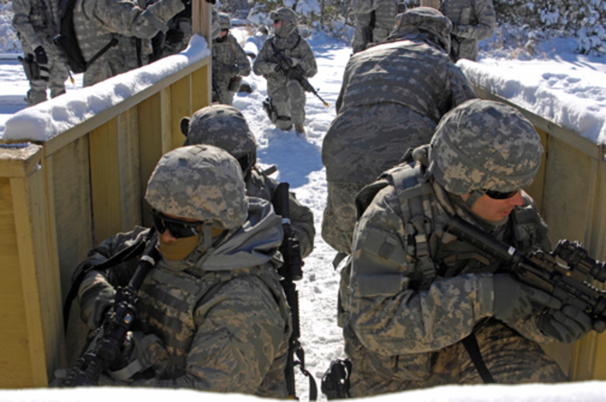 Senior Airman Cassie Castillo, 21, from Riverside, Calif., and Staff Sgt. Jeffrey Fay, 29, of Palisade, Colo., both members of Air Force Alpha 6, lead a team in learning how to enter and clear a building during recent training at Fort Dix. The building they trained in is called a glass house because trainers can see how trainees are performing. (U.S. Army photo/Lisa Evans) 