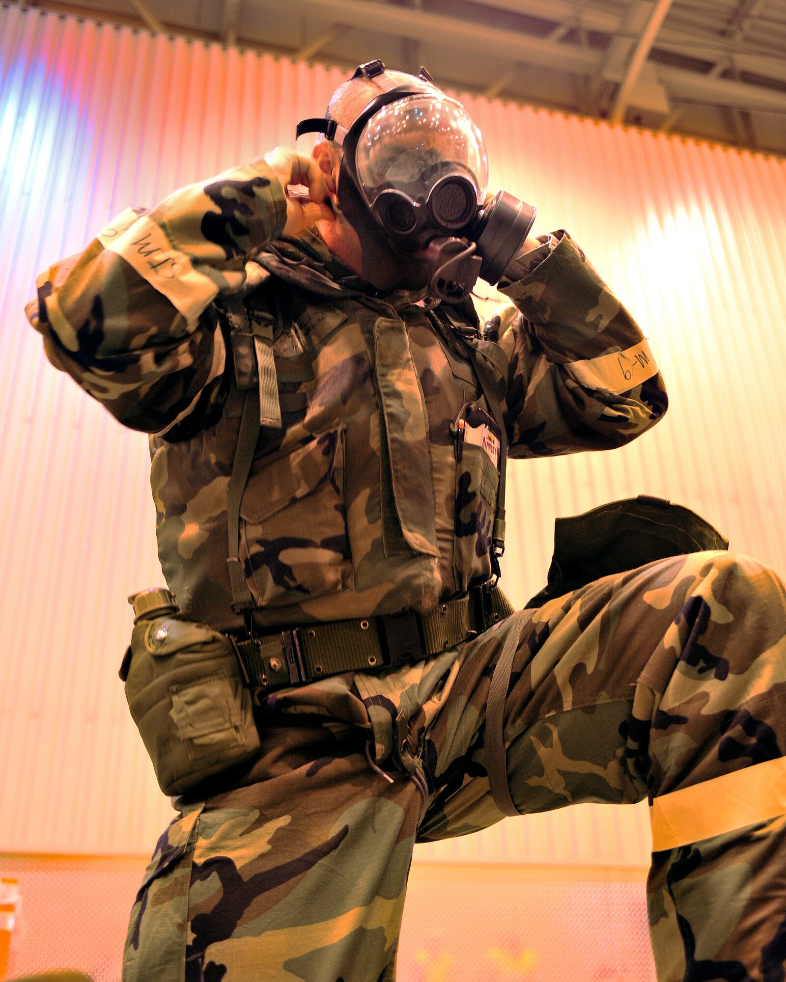 An Airman from the 354th Fighter Wing puts on personal protection equipment in the Ability to Survive and Operate training Feb. 12, 2009 at Eielson Air Force Base, Alaska. In the donning portion of the training Airmen practice dressing in the respective mission oriented protective posture. MOPP levels dictate the amount of PPE worn and are set in accordance with a threat. (U.S. Air Force photo/Airman 1st Class Willard E. Grande II)
