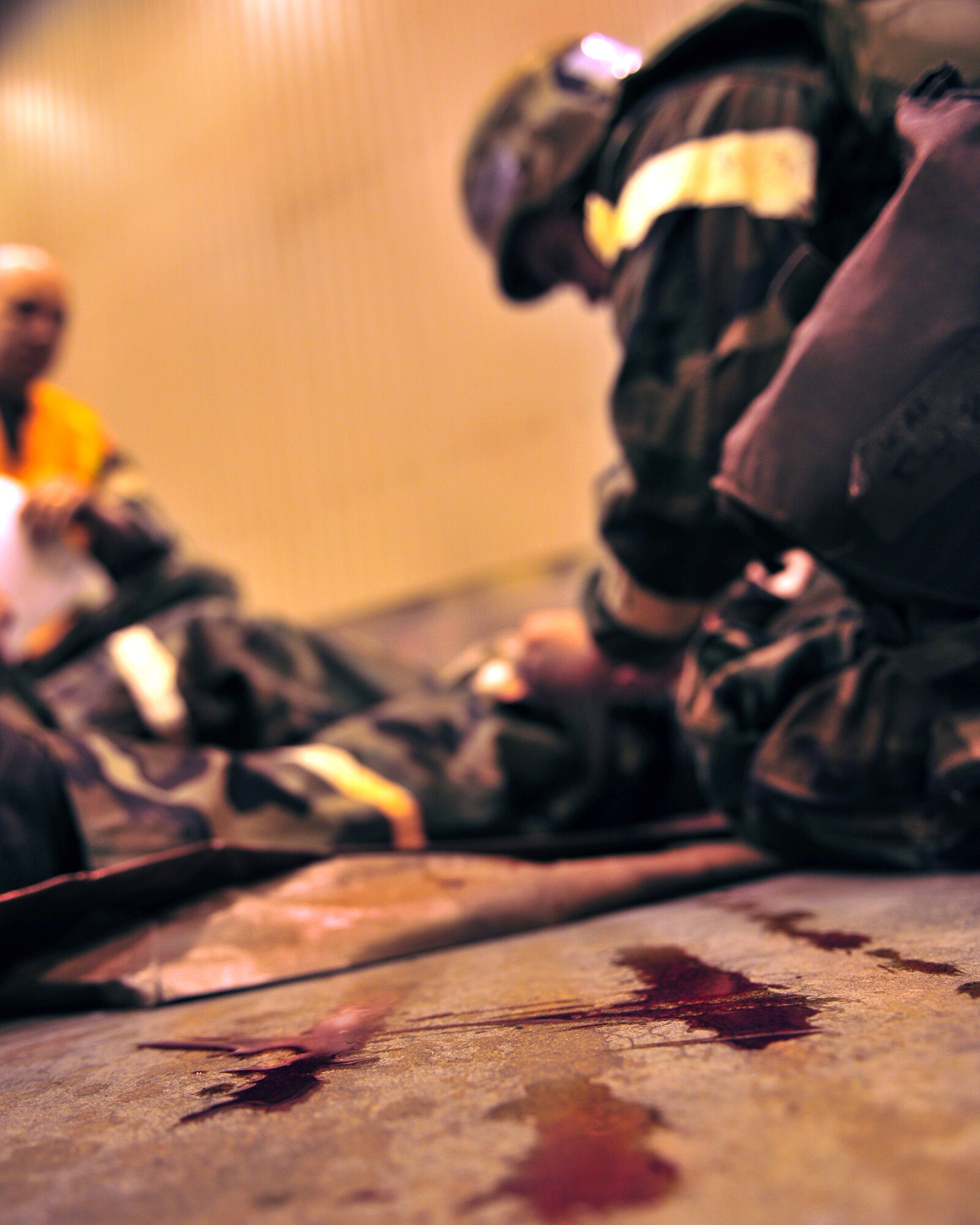 Airmen from the 354th Fighter Wing participate the Ability to Survive and Operate training Feb. 12, 2009 at Eielson Air Force Base, Alaska. In the Self-Aid  Buddy Care  portion of the training Airmen practice treating injuries commonly found on the battlefield in personal protective equipment. (U.S. Air Force photo/Airman 1st Class Willard E. Grande II)