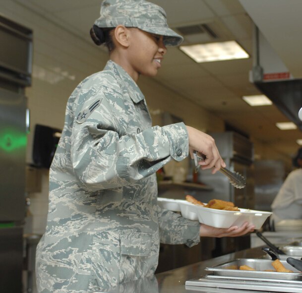 DYESS AIR FORCE BASE, Texas - Airman 1st Class Sharniece Clary serves an Airman breakfast Feb. 18 in the Longhorn Dining Facility. The Dyess Longhorn Dining Facility is competing for the Hennessey Trophy, awarded to the best dining service in the Air Force. Evaluators for the award will be at Dyess Feb. 19-22. Airman Clary is a member of the 7th Force Support Squadron. (U.S. Air Force photo by Staff Sgt. Joel Mease)