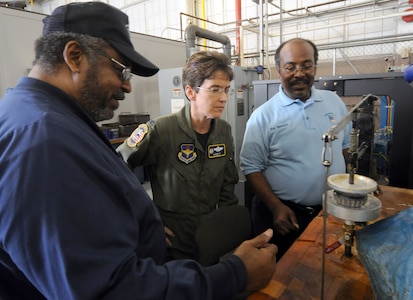 Col. Jacqueline Van Ovost (center), 12th Flying Training Wing commander, listens to Lou Chatman (left) and Roy Spencer talk about the new Aircraft Wheel and Tire Shop in Hangar 16 on Feb. 13. The new $53,000 facility features upgrades like separate work and break areas, a fire-suppression system, better lighting and a much-improved temperature and humidity control. (U.S. Air Force photo by Steve White)