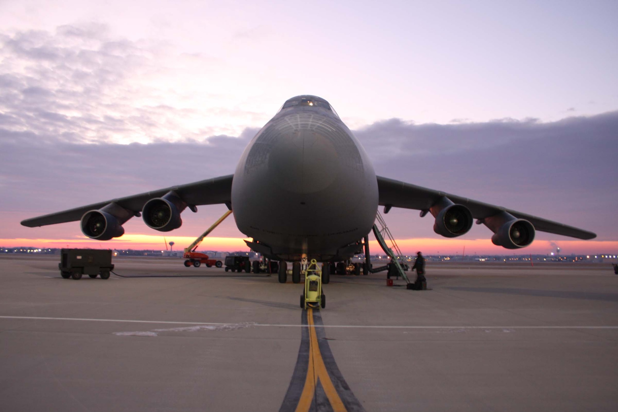 WRIGHT-PATTERSON AFB, Ohio – The sun rising in the background provides the perfect backdrop for a C-5 Galaxy being prepped for a mission early one winter morning. (Air Force photo/Senior Airman Ken LaRock)