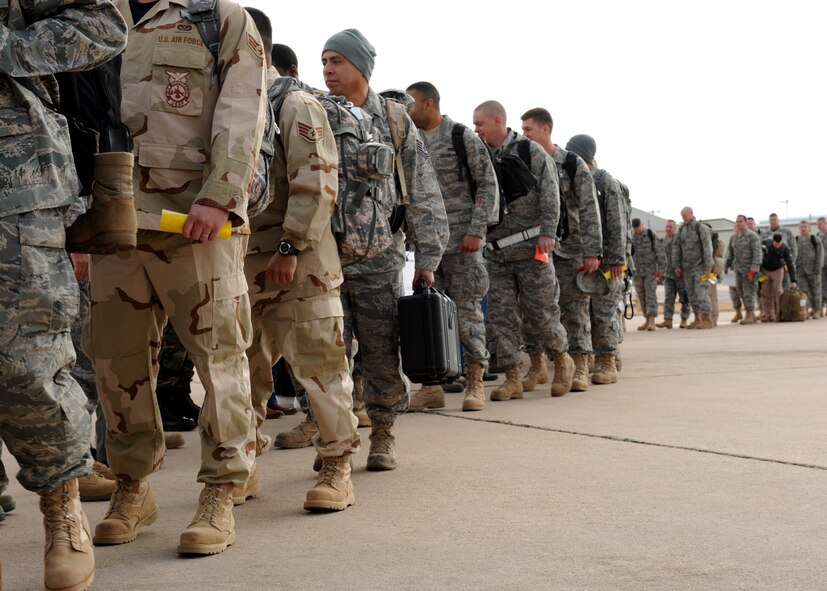 DYESS AIR FORCE BASE, Texas - Members of the 317th Airlift Group and 7th Bomb Wing board a flight for a deployment to Southwest Asia here Feb. 14. (U.S. Air Force Photo by Airman 1st Class Stephen Reyes)