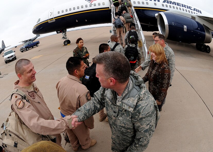 DYESS AIR FORCE BASE, Texas - Members of the 317th Airlift Group and 7th Bomb Wing board a flight for a deployment to Southwest Asia here Feb. 14. (U.S. Air Force Photo by Airman 1st Class Stephen Reyes)