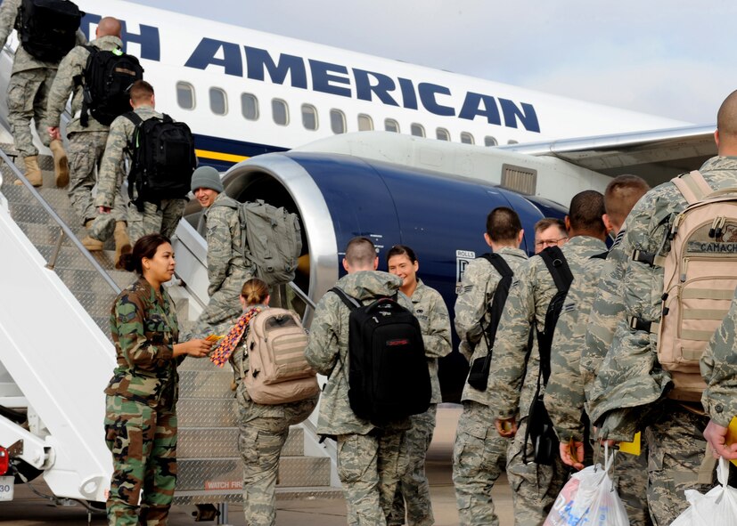 DYESS AIR FORCE BASE, Texas - Members of the 317th Airlift Group and 7th Bomb Wing board a flight for a deployment to Southwest Asia here Feb. 14. (U.S. Air Force Photo by Airman 1st Class Stephen Reyes)