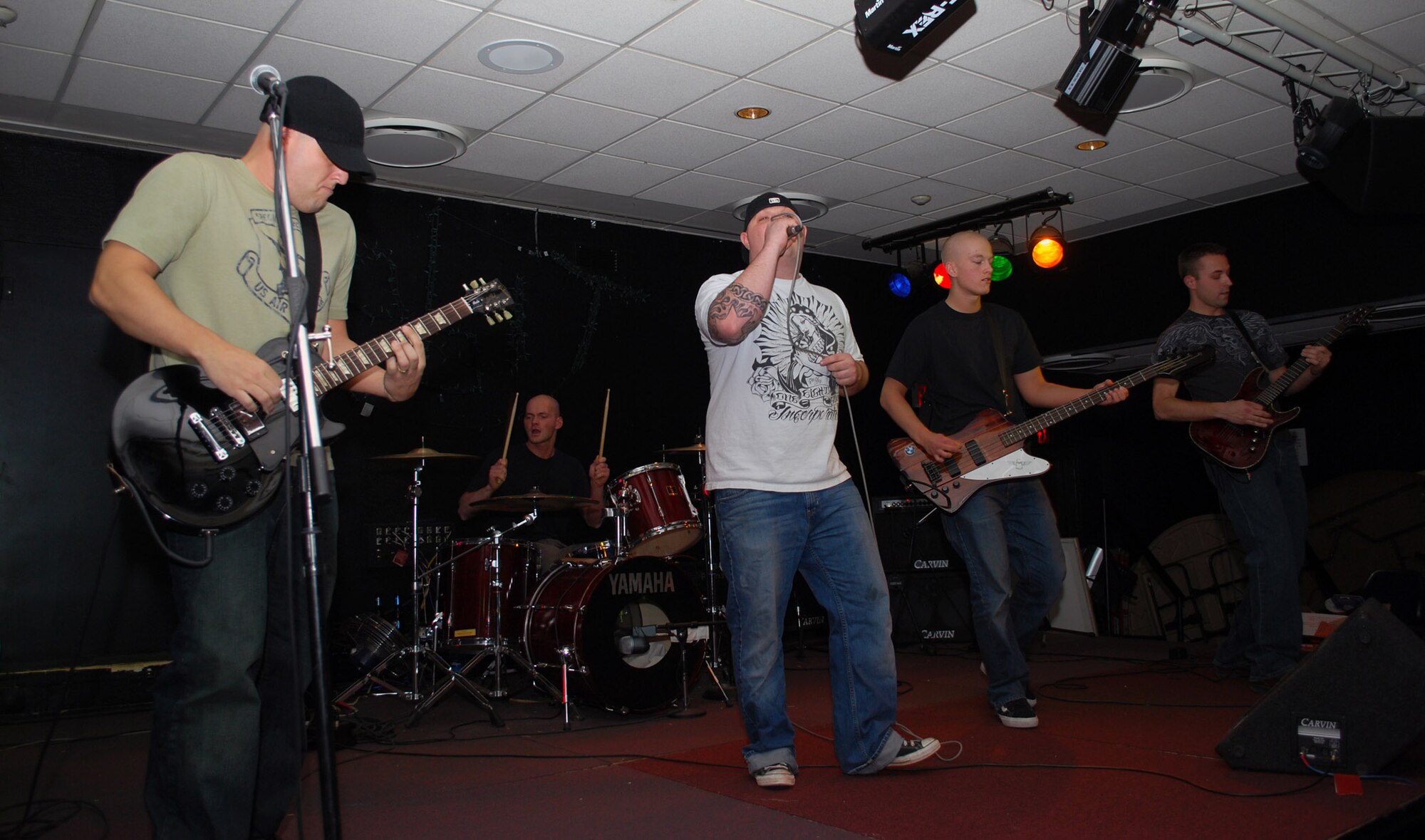 The Jelly Flickers, a Thule band made up of American and Danish employees, rock out at the Top of the World Club Feb. 13 one more time before two of the band members leave Thule for another duty station. The band members are (from left to right) Tech. Sgt. John Morrison, 12th Space Warning Squadron, on guitar and backup vocals; Jakob Petersen, Greenland Contracting, on drums; Staff Sgt. Steve Rider, 821st Security Forces Squadron, on lead vocals; Airman 1st Class Eric Fowler, 821st SFS, on bass guitar; and Staff Sgt. Jim Selix, 12th SWS, on lead guitar (Photo by 1st Lt. Lisa Meiman).