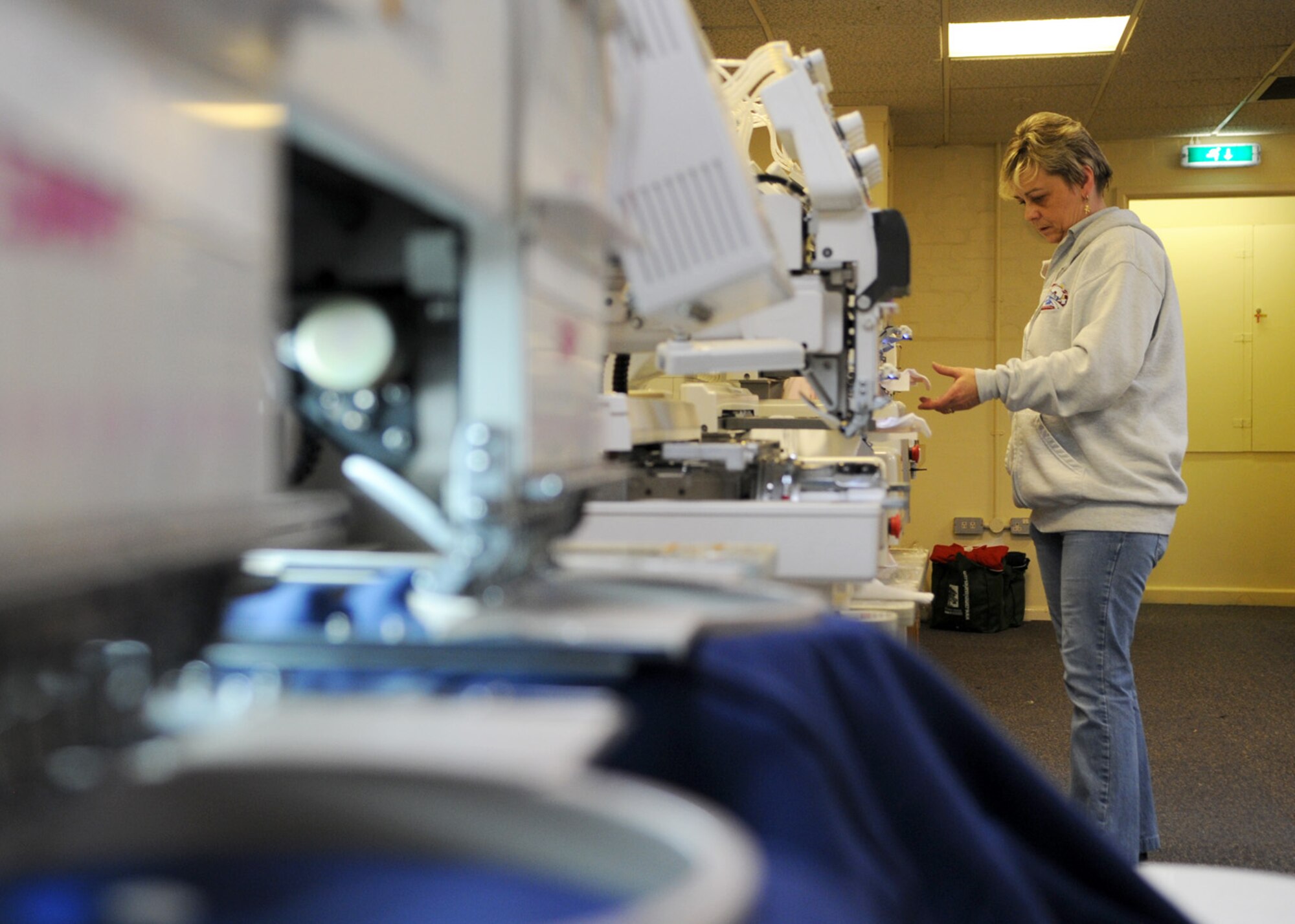 Sarah Jakes works with six embroidering machines simultaneously creating an array of custom embroidered products at the Arts and Crafts Center Jan. 28, 2009, at RAF Mildenhall, England. Mrs. Jakes is able to embroider almost any type of fabric material, to create a custom or personalized item. For more information about embroidering, contact the Arts and Crafts Center in Building 422 at DSN 238-2644/4101. (U.S. Air Force photo by Staff Sgt. Jerry Fleshman)
