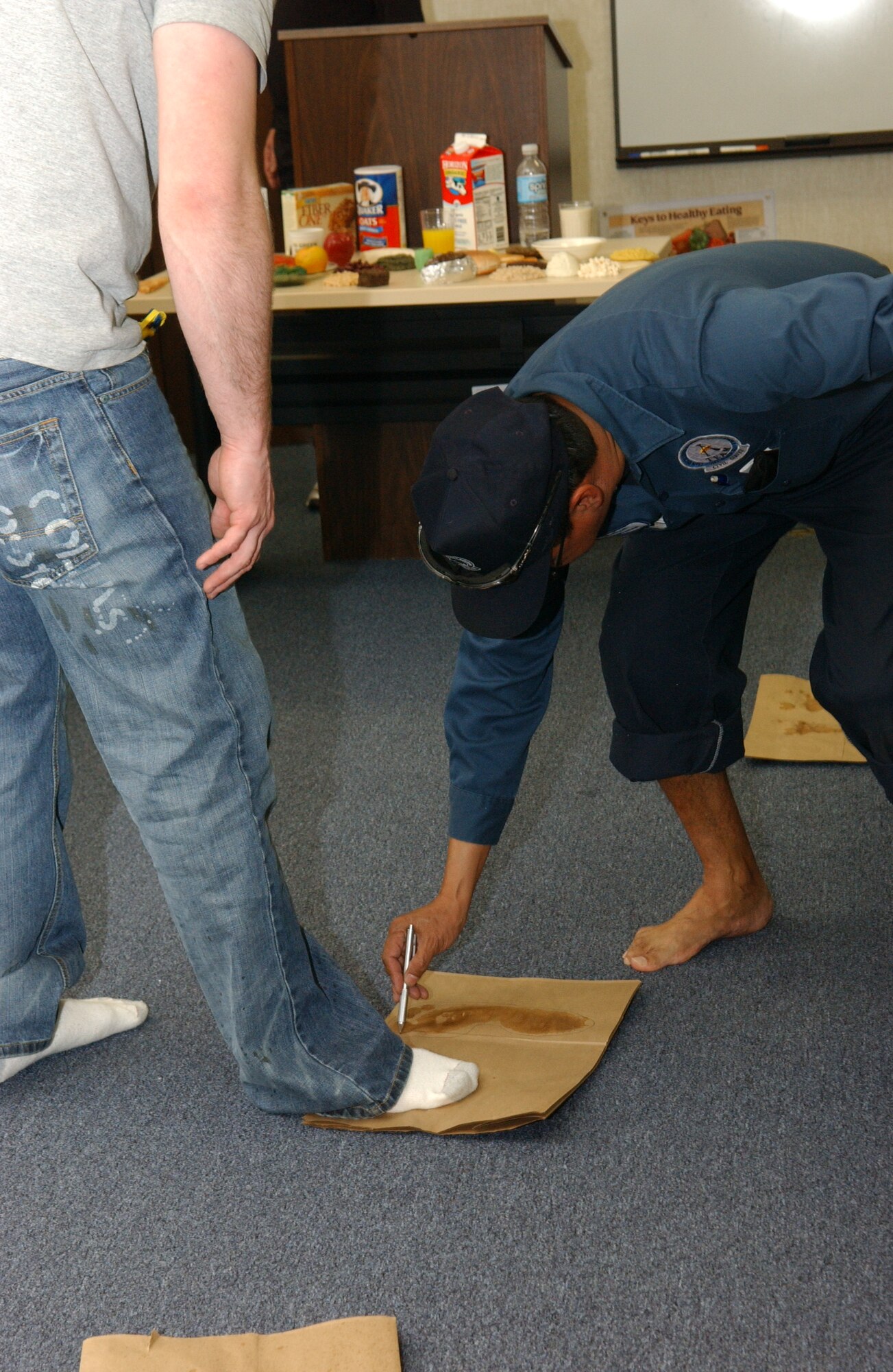 ALTUS AIR FORCE BASE, Okla. – Members of the Shoe Clinic Class given on Feb. 12 wet their feet to find out what kind of arch their foot has. Knowing what kind of arch your foot has helps determine the proper shoes to wear while running. According to Karl Leonard, the Health and Wellness Center exercise physiologist, running related injuries are usually caused by improper shoes. For more information on the proper shoes for you, contact Karl Leonard at 481-5013. (U.S. Air Force Photo/Airman 1st Class Leandra D. Hernandez) 
