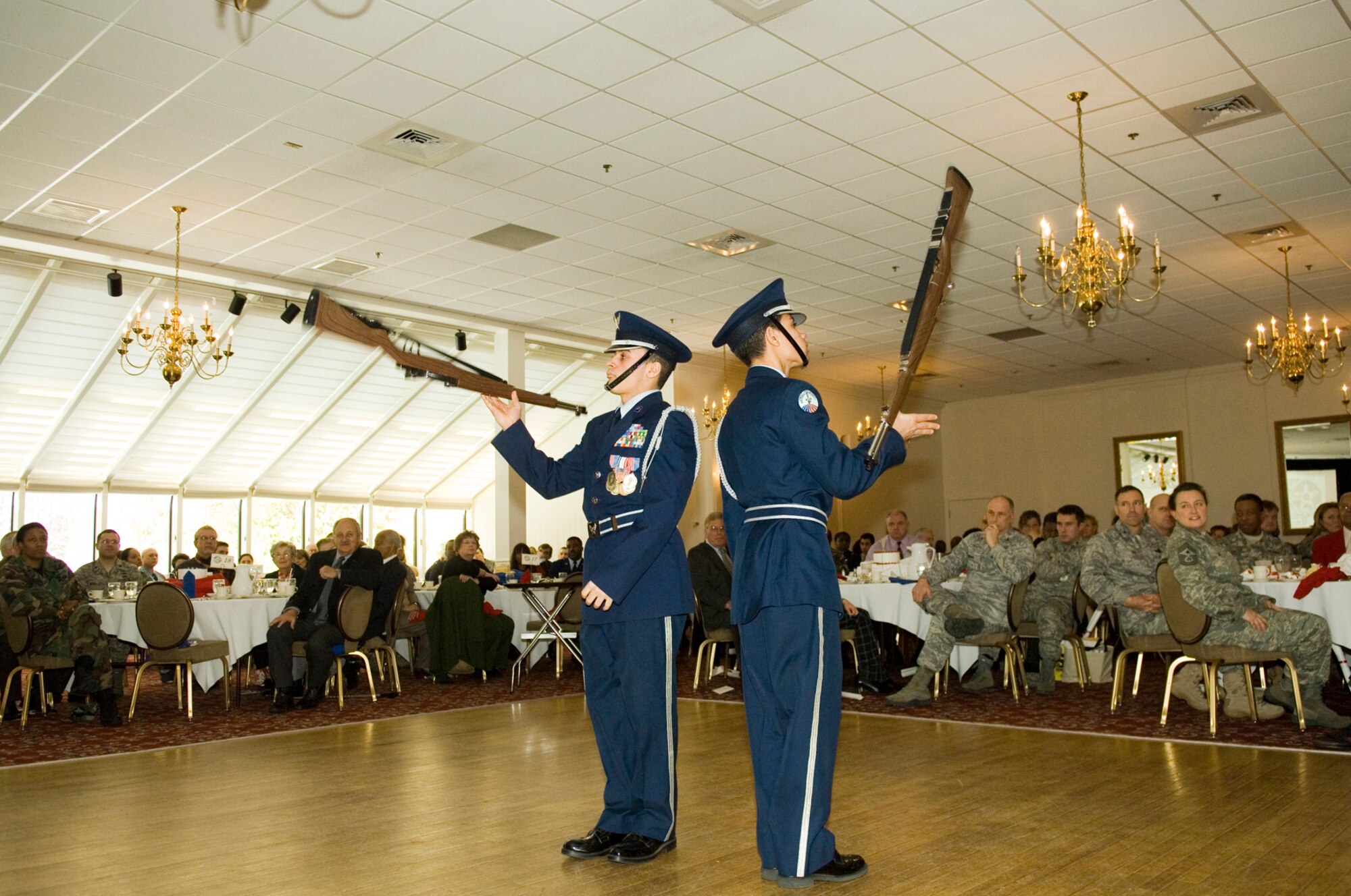 HANSCOM AIR FORCE BASE, Mass. – Lowell High School Junior ROTC drill team members perform a rifle demonstration for a capacity crowd at the Minuteman Club on Feb. 11, during an event sponsored by the Col. Charles McGee Chapter of Tuskegee Airmen, Inc. The luncheon featured guest speaker Col. Charles McGee and other original members of the Tuskegee Airmen. (U.S. Air Force photo by Rick Berry)