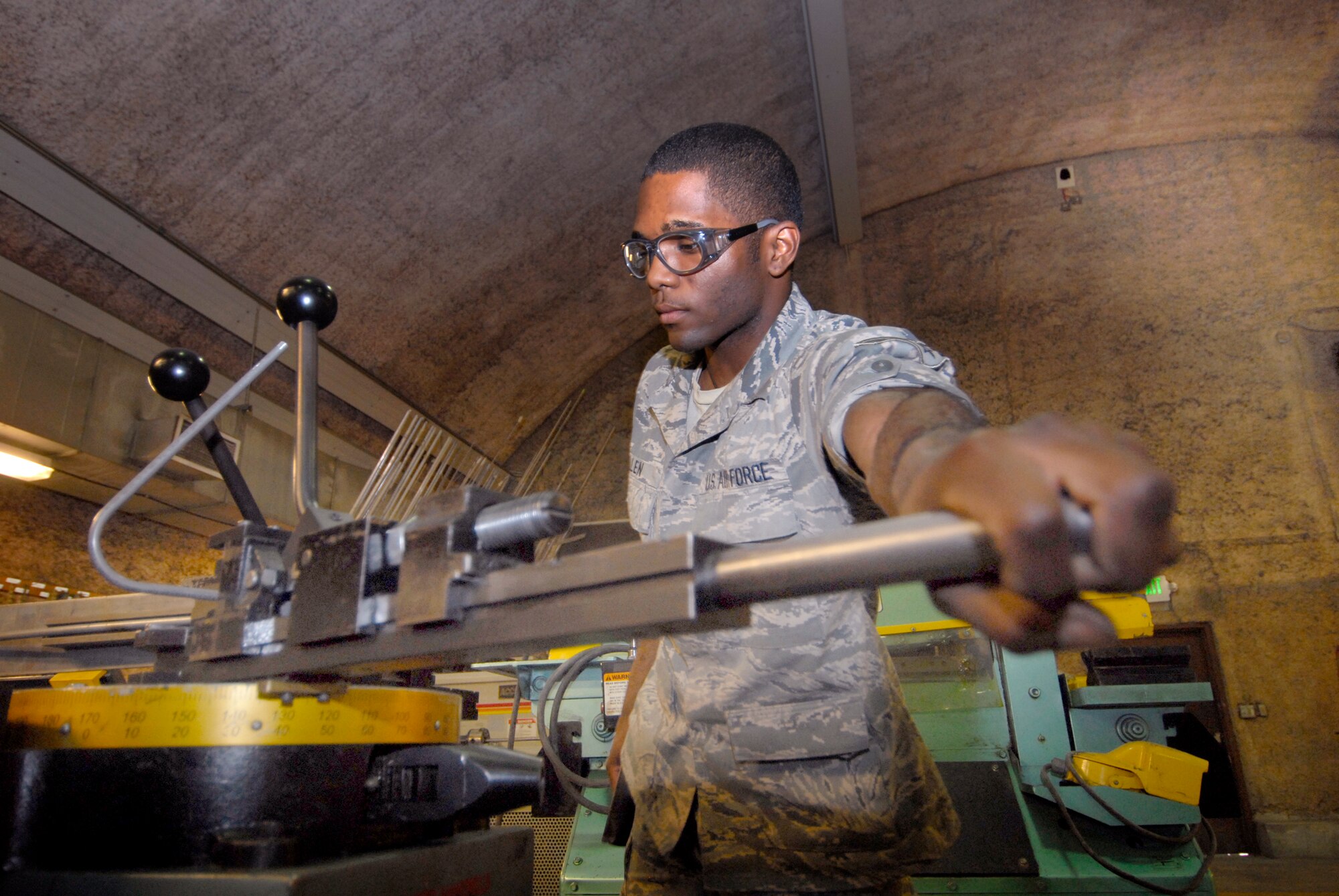 Senior Airman John Allen, 379th Expeditionary Maintenance Squadron Aircraft Structural Maintenance Journeyman, bends a hydraulic pipe to get the proper curvature for a project in the fabrication shop, Feb. 17, 2009, at an undisclosed location in Southwest Asia.  Senior Airman Allen hails from Houston, Texas and is deployed from Dyess Air Force Base, Texas in support of Operations Iraqi and Enduring Freedom and Combined Joint Task Force - Horn of Africa. (U.S. Air Force Photo by Airman 1st Class Andrew Satran/Released)