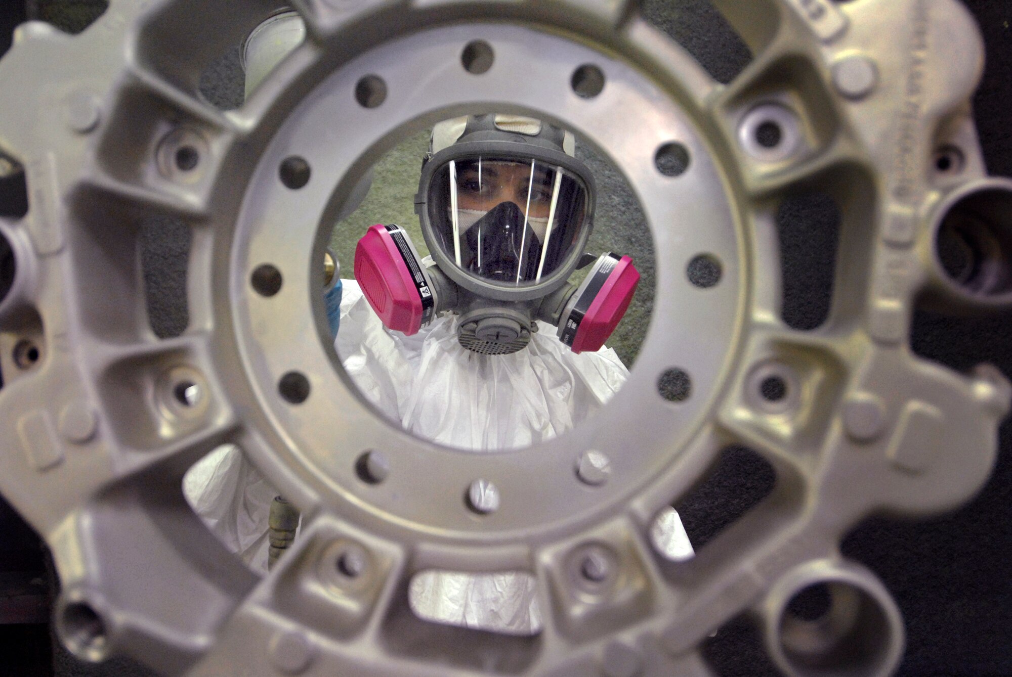 Senior Airman Robert Shawl, a 379th Expeditionary Maintenance Squadron Aircraft Structural Maintenance Journeyman, paints a hydraulic brake housing in the paint booth, Feb. 17, 2009, at an undisclosed location in Southwest Asia.  Senior Airman Shawl hails from Inarajan, Guam and is deployed from Grand Forks Air Force Base, N.D. in support of Operations Iraqi and Enduring Freedom and Joint Task Force - Horn of Africa.  (U.S. Air Force photo/Airman 1st class Andrew Satran/released)