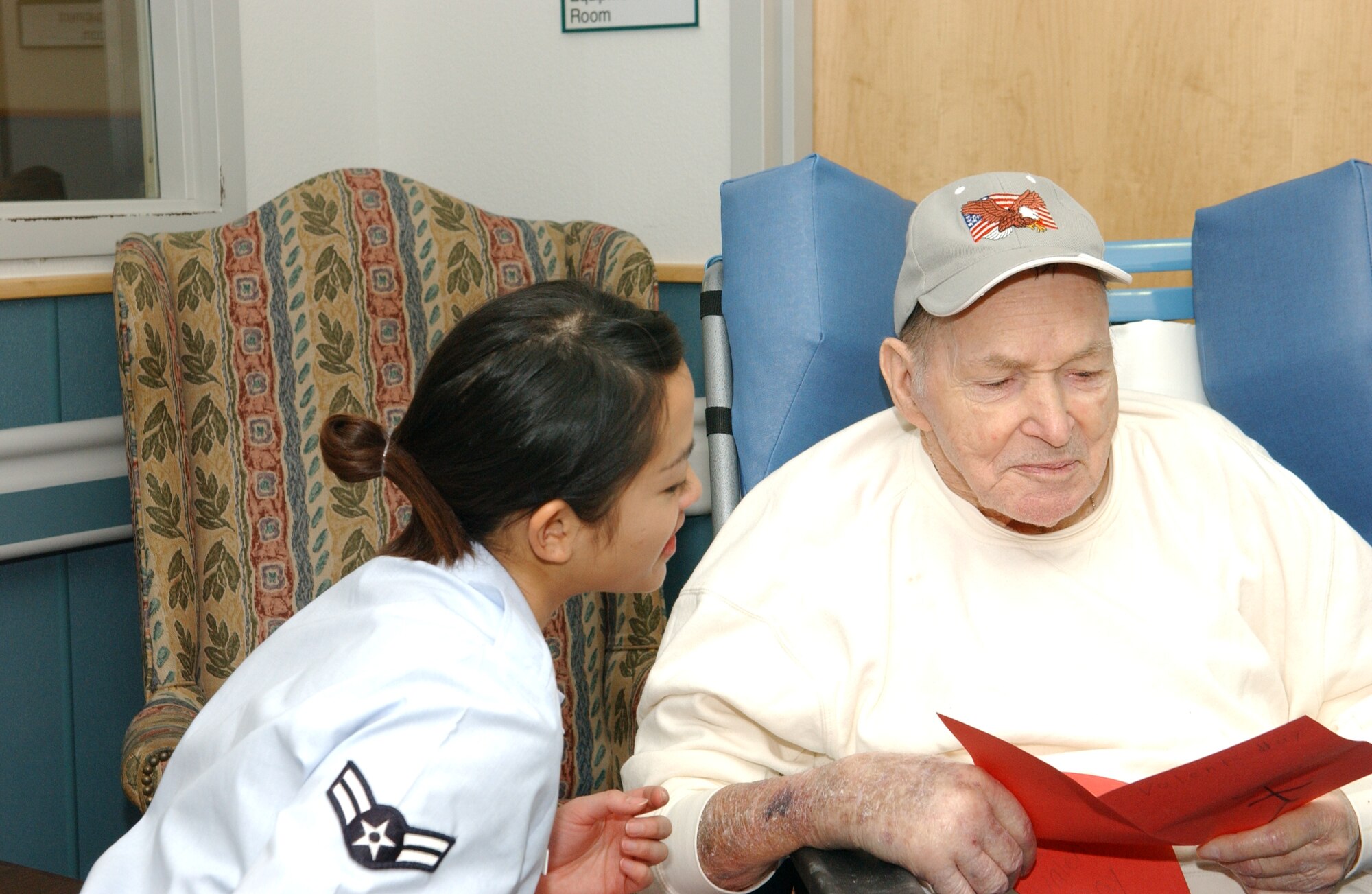 ALTUS AIR FORCE BASE, Okla. – Airman First Class Emily Seeboonruang from the 97th Force Support Squadron, presents Vernon Wynn, a retired veteran of the Army, with a valentine made by students of Altus schools. Members of Altus AFB traveled to the Oklahoma Veterans Center in Clinton, Okla. to pass out over 200 valentines for the annual Valentines for Vets. (U.S. Air Force Photo/Airman 1st Class Leandra D. Hernandez) 