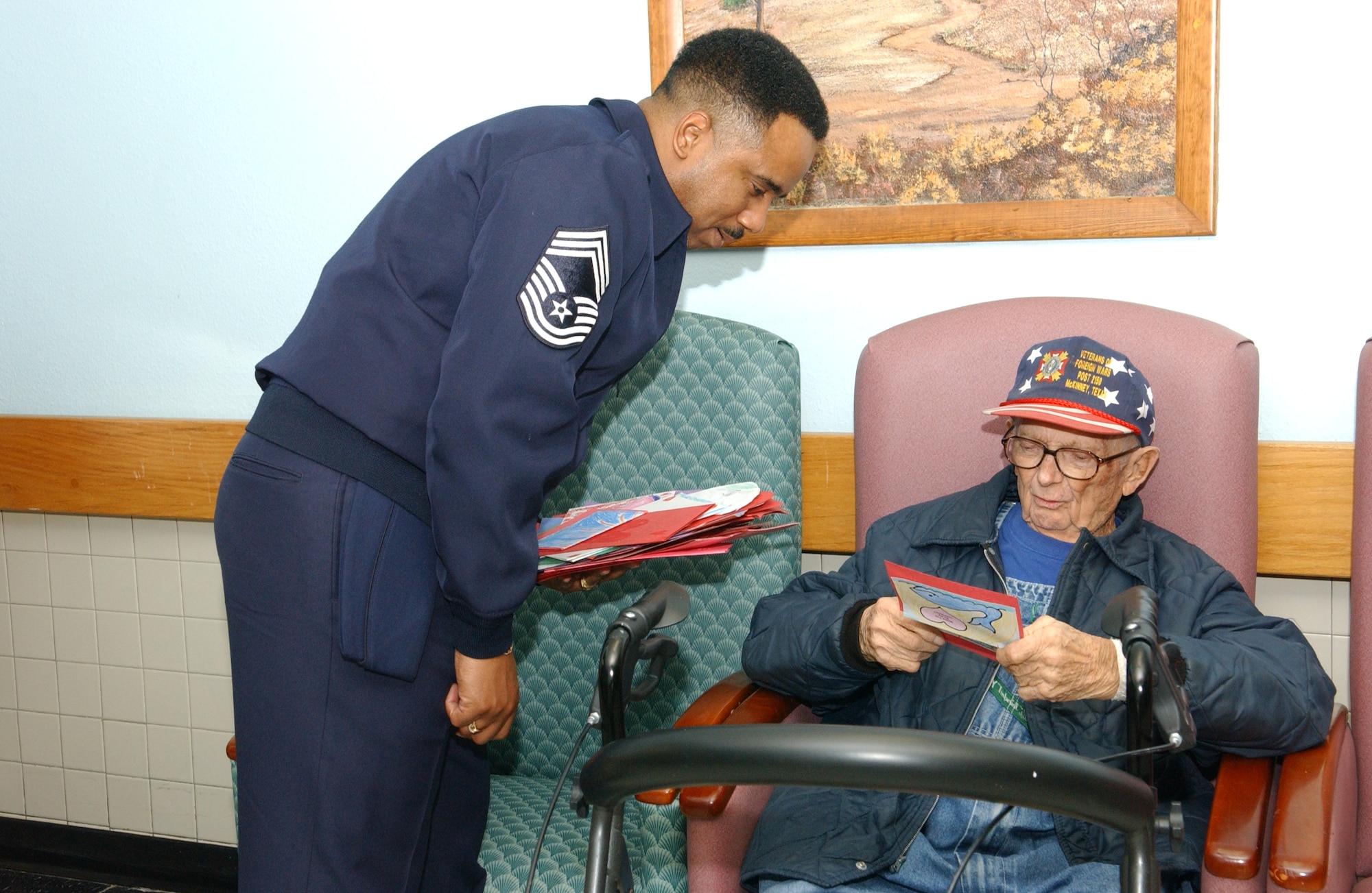ALTUS AIR FORCE BASE, Okla. – Chief Master Sgt. Raymond Smith, 97th Force Support Squadron, presents George Clendennen, a veteran of the Air Force, with a valentine made by students of Altus schools. Members of Altus AFB traveled to the Oklahoma Veterans Center in Clinton, Okla. to pass out over 200 valentines for the annual Valentines for Vets. (U.S. Air Force Photo/Airman 1st Class Leandra D. Hernandez) 