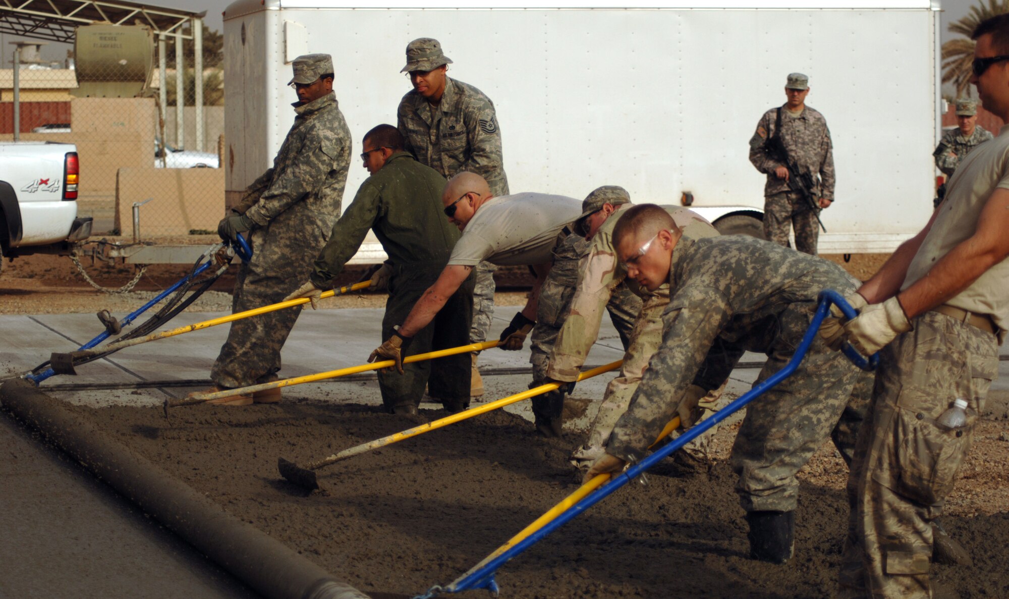 JOINT BASE BALAD, Iraq - Construction equipment operators or ?Dirt Boys? from the 332nd Expeditionary Civil Engineer Squadron complete a 76-meter concrete pad during a construction project here Feb. 15. (U.S. Air Force photo/Staff Sgt. Dilia Ayala)