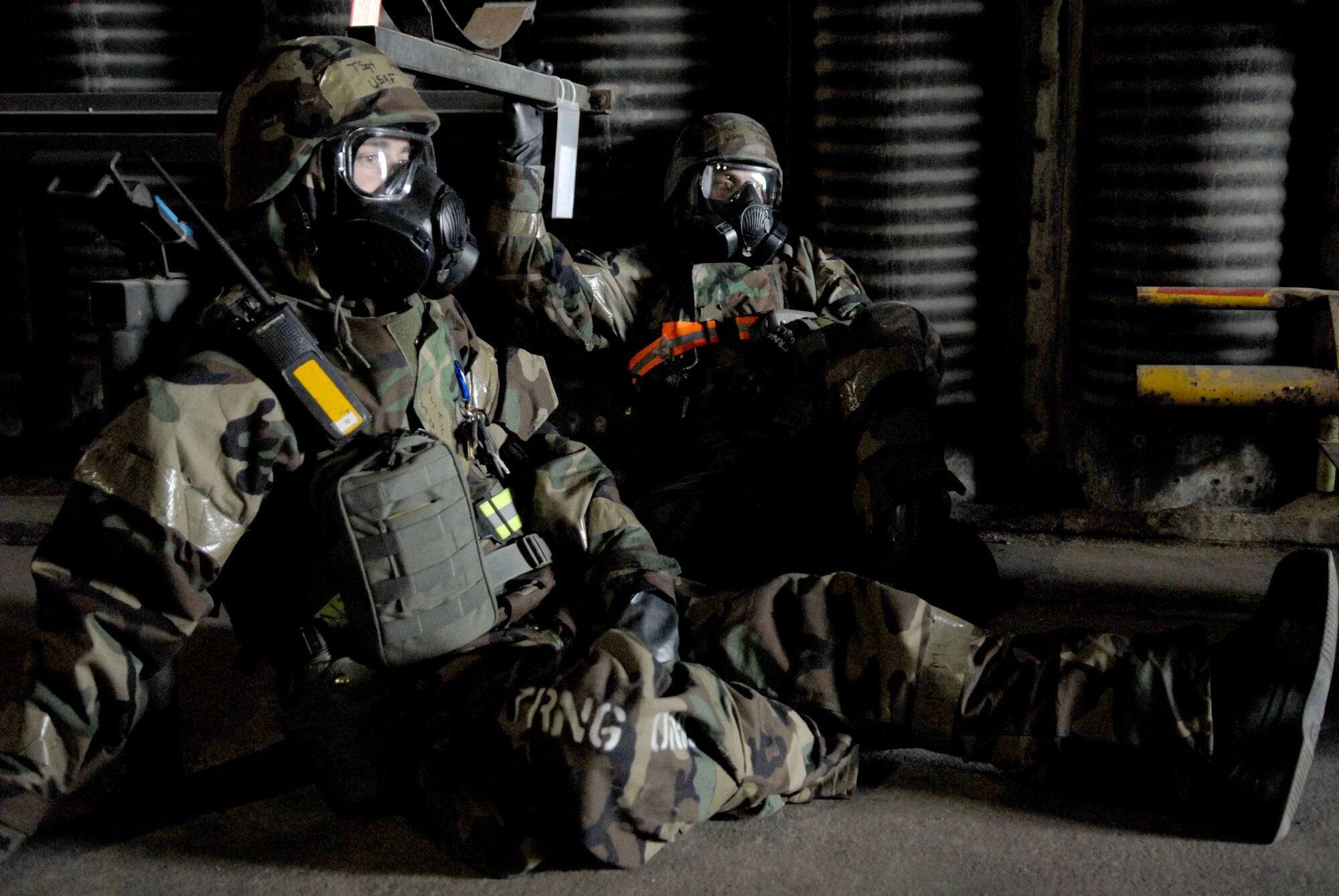 Airmen from the 51st Logistics Readiness Squadron seek shelter in a hardened aircraft shelter during Mission Oriented Protective Posture four, during the 51st Fighter Wing?s Operational Readiness Exercise Beverly Midnight 09-01 at Osan AB, Republic of Korea, Feb. 9.  (U.S. Air Force Photo/Staff Sgt. Brian Ferguson)