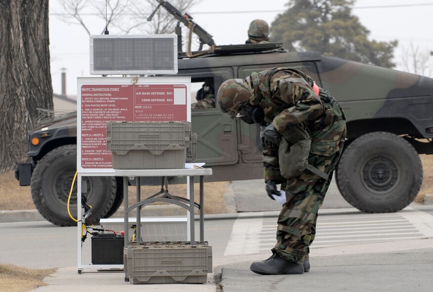 Staff Sgt. Steven Hammett transitions from mission oriented protective measure four to MOPP two, as he goes to work during the 51st Fighter Wing?s Operational Readiness Exercise Beverly Midnight 09-01 at Osan AB, Republic of Korea, Feb. 10.  Sergeant Hammett is crew chief assigned to the 36th Aircraft Maintenance Unit. (U.S. Air Force Photo/Staff Sgt. Brian Ferguson)