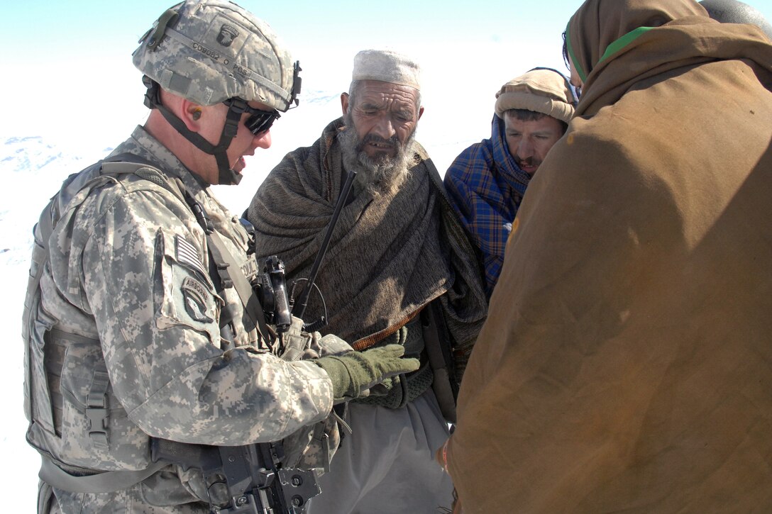 A U.S. Army Soldier Talks To Afghan Elders In Bagram, Afghanistan, Feb ...