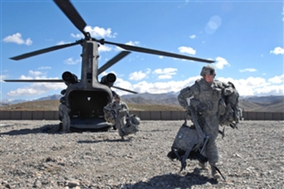 U.S. Army Pvt. Bryce Vittetoe exits a CH-47 Chinook Cargo Helicopter on Forward Operating Base Lane in Zabul province, Afghanistan, Feb. 14, 2009. Vittetoe is assigned to Company B, 1st Battalion, 4th Infantry Regiment.