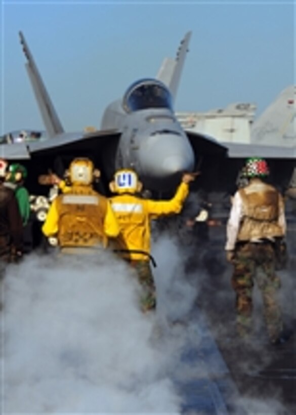 A U.S. Navy F/A-18E Super Hornet aircraft assigned to Strike Fighter Squadron 31 is directed toward a catapult during flight operations aboard the aircraft carrier USS Theodore Roosevelt (CVN 71) while the ship is underway in the Gulf of Oman on Feb. 16, 2009.  The ship and embarked Carrier Air Wing 8 are operating in the U.S. 5th Fleet area of responsibility.  