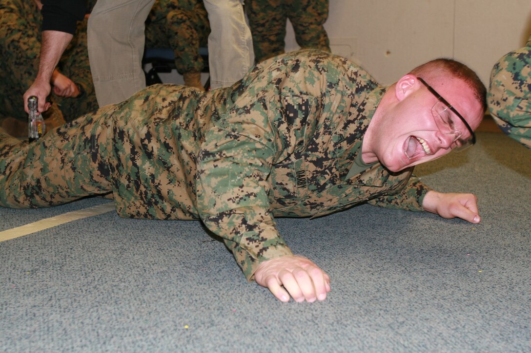 Cpl. Jason Darby, Body Bearer, Bravo Company, Marine Barracks Washington, receives an electric shock during nonlethal weapons training at the Barracks, Feb. 19.