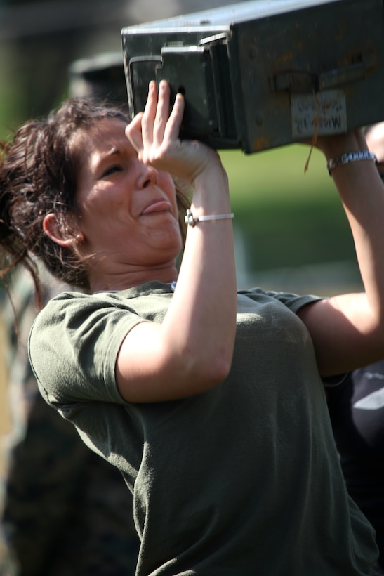 Kelsey Neill, wife of Pfc. Cory Neill, motor transport mechanic, Maintenance Battalion, Combat Logistics Regiment 15 1st Marine Logistics Group, performs ammo can lifts during the Combat Fitness Test portion of Jane Wayne day.