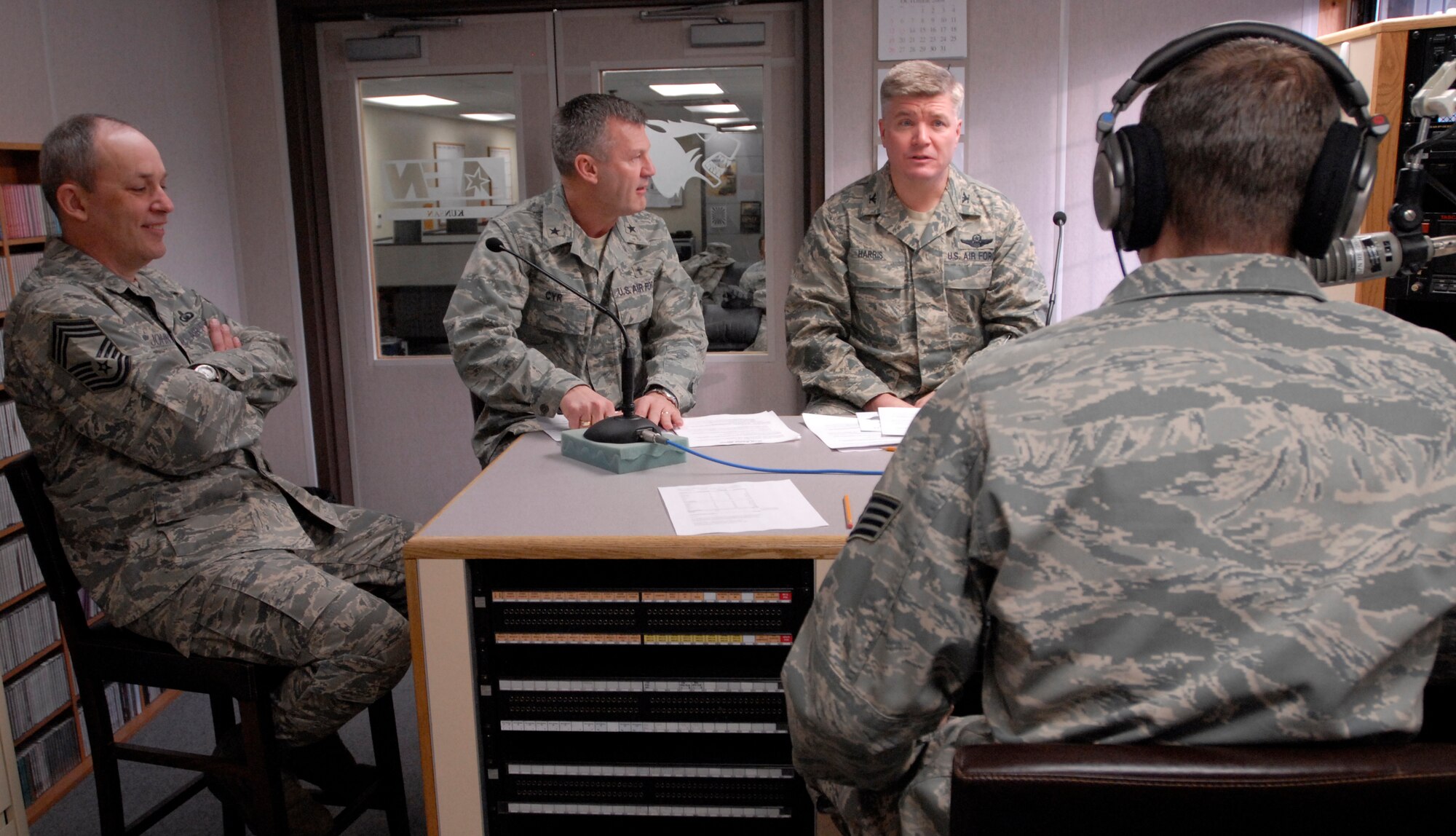 Chief Master Sgt. Charles Johnson, Air Force Chaplain Assistant career field manager, Chaplain (Brig. Gen.) David Cyr, Air Force deputy chief of chaplains and Col. J.D. "Wolf" Harris, 8th Fighter Wing commander, speak with Staff Sgt. Aaron Drobnack, American Forces Network Korea, during the Aaron in the Morning radio show at Kunsan Air Base, Republic of Korea, Feb. 20, 2009. Chaplain Cyr visited the Wolf Pack to be the guest speaker at the National Prayer Luncheon at Kunsan Air Base, Republic of Korea, Feb. 20, 2009. (U.S. Air Force Photo/Senior Airman Gustavo Gonzalez)