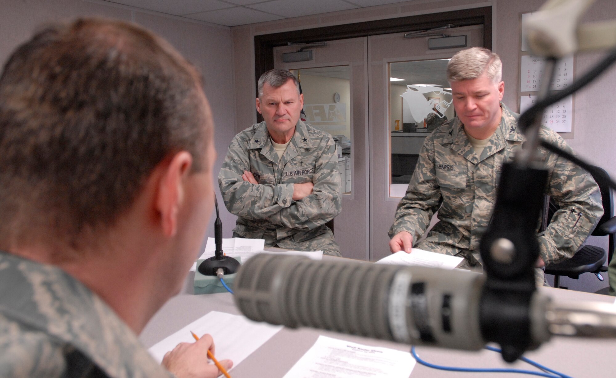 Staff Sgt. Aaron Drobnack, American Forces Network Kunsan, speaks with Chaplain (Brig. Gen.) David Cyr, Air Force deputy chief of chaplains and Col. J.D. "Wolf" Harris, 8th Fighter Wing commander, during the Aaron in the Morning radio show at Kunsan Air Base, Republic of Korea, Feb. 20, 2009. Chaplain Cyr visited the Wolf Pack to be the guest speaker at the National Prayer Luncheon. (U.S. Air Force Photo/Senior Airman Gustavo Gonzalez)