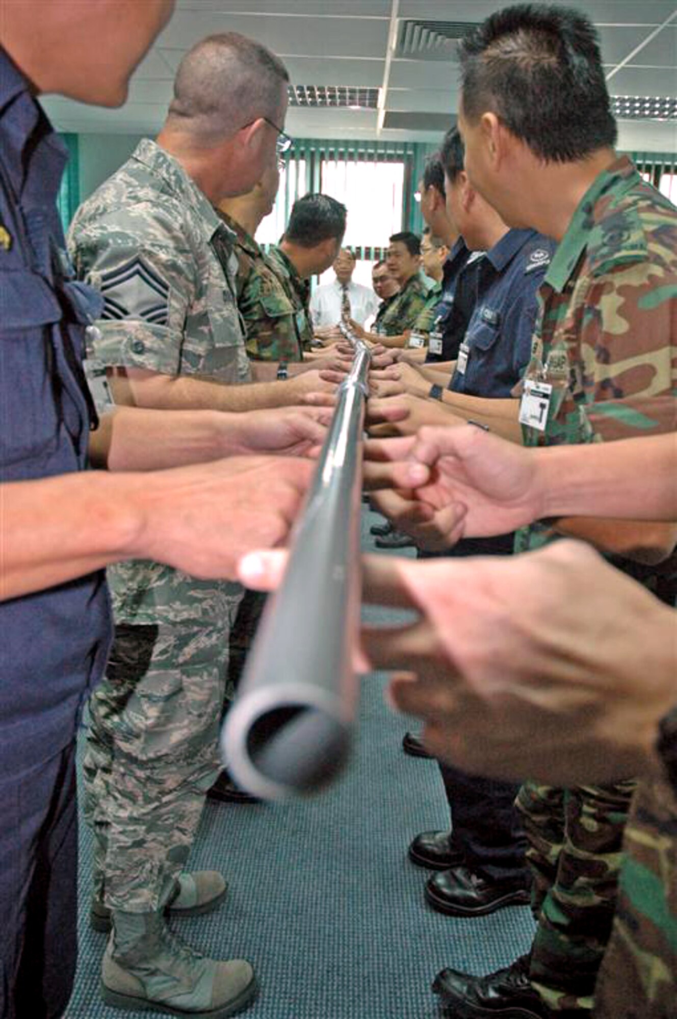 Senior Master Sgt. Duncan, director of operations at Kadena's Erwin Professional Military Education Center, partakes in a team building exercise at Singapore's Armed Forces Warrant Officer School.  Sergeant Duncan is attending the school in search of valuable insights to add to the U.S. Air Force's professional military education. (Courtesy photo)     