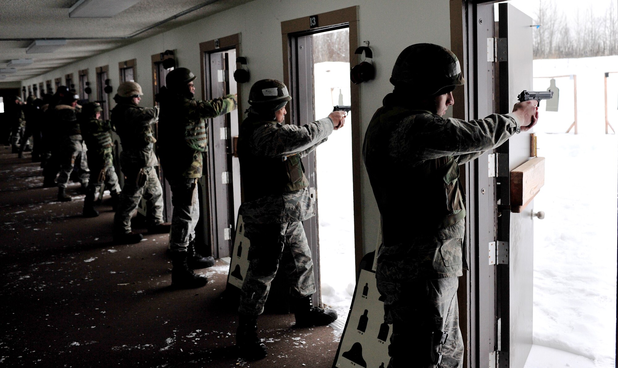 Airmen from the 354th Fighter Wing, qualify with the M-9 pistol Feb. 18, 2009 at the 354th Security Forces Squadron Combat Arms Training and Maintenance Facility on Eielson Air Force Base, Alaska. CATM also qualifies personnel on the MK-19 and M-203 grenade launchers, M-240 machine gun and M-249 Squad Automatic Weapon, AT-4 anti-tank weapon, M-16 rifle, M-4 carbine, M-870 shotgun, and M-24 sniper rifle. (U.S. Air Force photo/Airman 1st Class Willard E. Grande II)