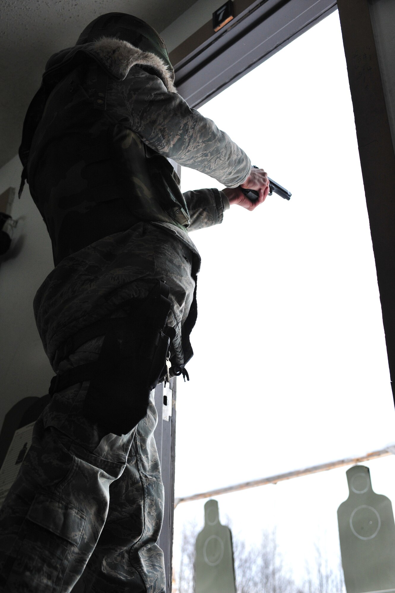 Master Sergeant Roy Pflughoeft, 354th Civil Engineering Squadron, fires an M-9 Feb. 18, 2009 at the 354th Security Forces Squadron Combat Arms Training and Maintenance Facility on Eielson Air Force Base, Alaska. The M-9 qualification course requires students to be accurate at varying distances and proficient at placing rounds in two different sized targets. Airmen fired during sub-zero temperatures which can make qualification more challenging. (U.S. Air Force photo/Airman 1st Class Willard E. Grande II)