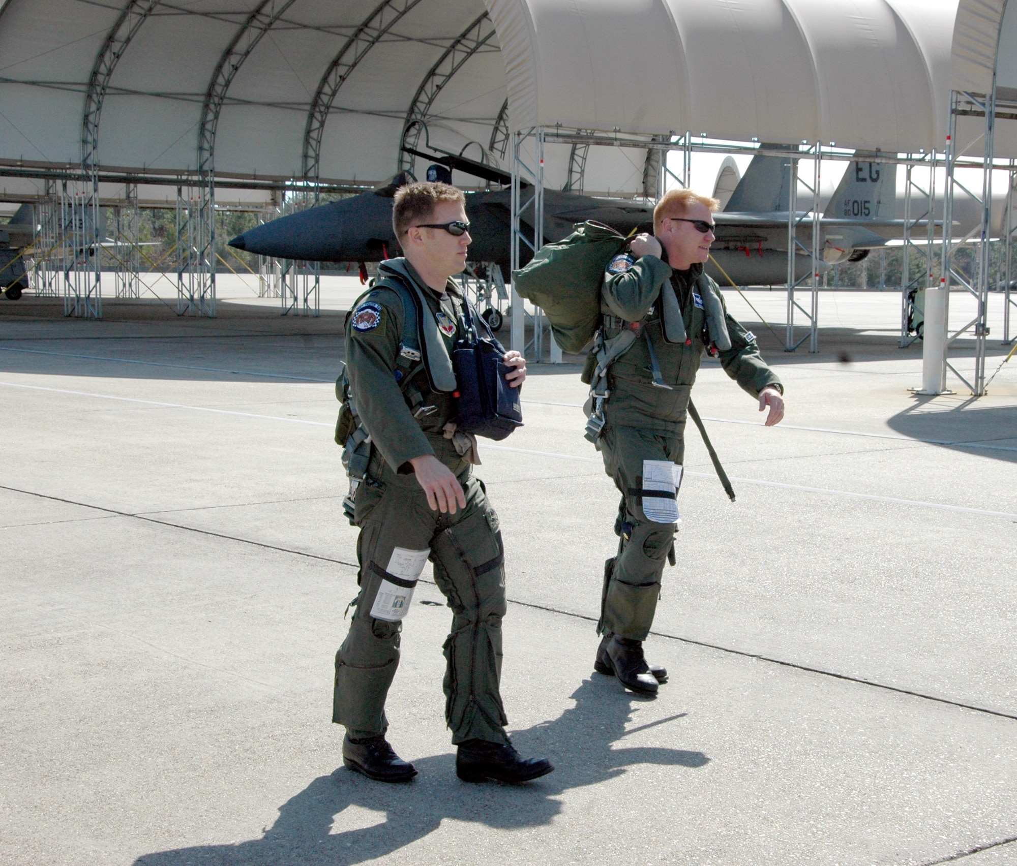 EGLIN AIR FORCE BASE, Fla. – Capt. Michael Reilly, 58th Fighter Squadron C Flight commander, and Maj. Tony Cartwright, chief instructor pilot and weapons officer for the 58th FS, walk out to the jets on the runway ramp.  The 33rd Fighter Wing’s fighter pilots fly F-15C Eagles in air-to-air combat. (U.S. Air Force photo/Noel Getlin)