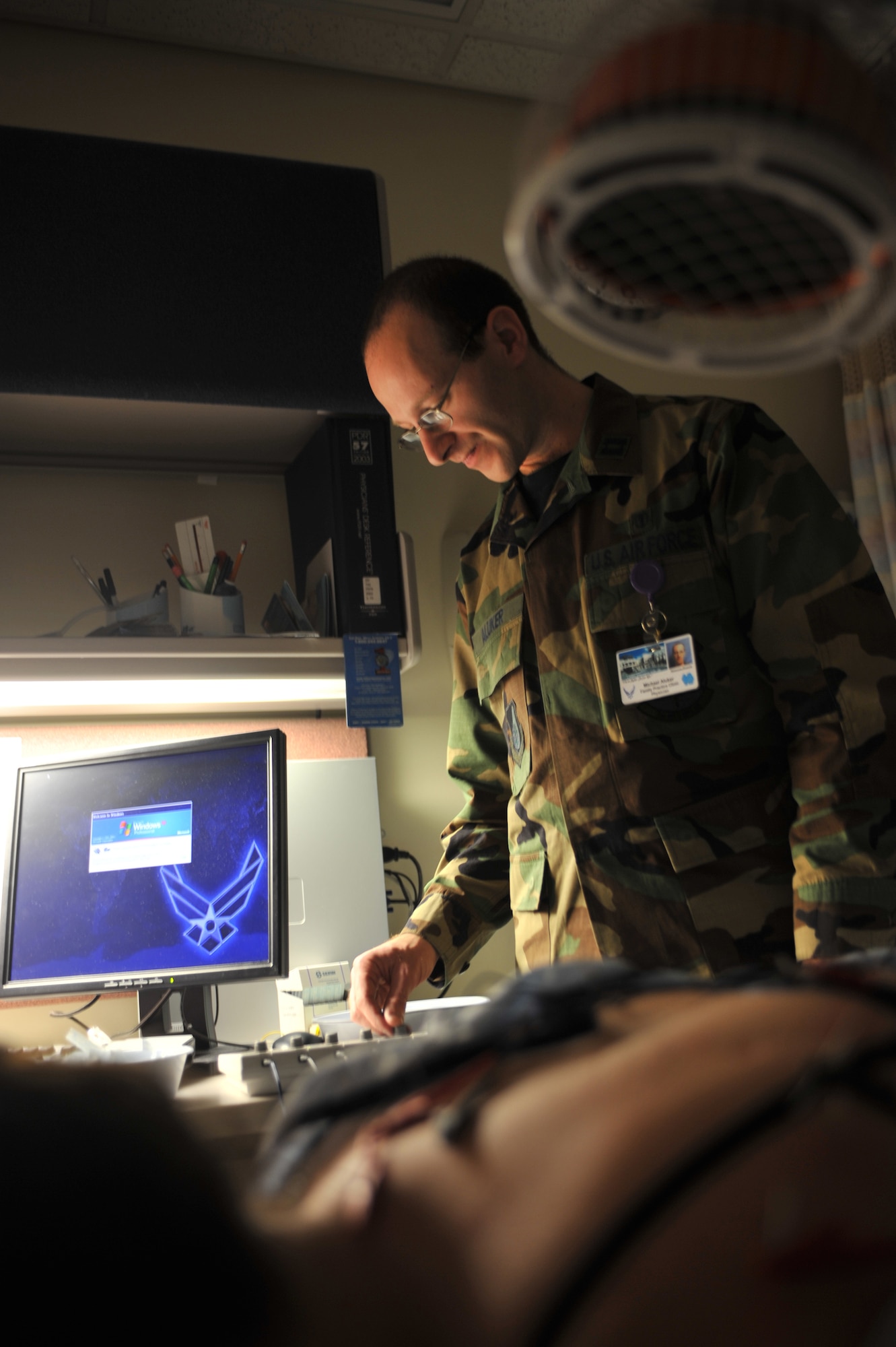 ELMENDORF AIR FORCE BASE, Alaska -- Capt. (Dr.) Michael Aluker adjusts the frequency of electrical impulses going through the needles. Many acupuncture treatments use alternating frequencies of high and low voltage impulses for altering the energy flow within the muscle or nerve segment. (U.S. Air Force photo/Senior Airman Tinese Treadwell)

