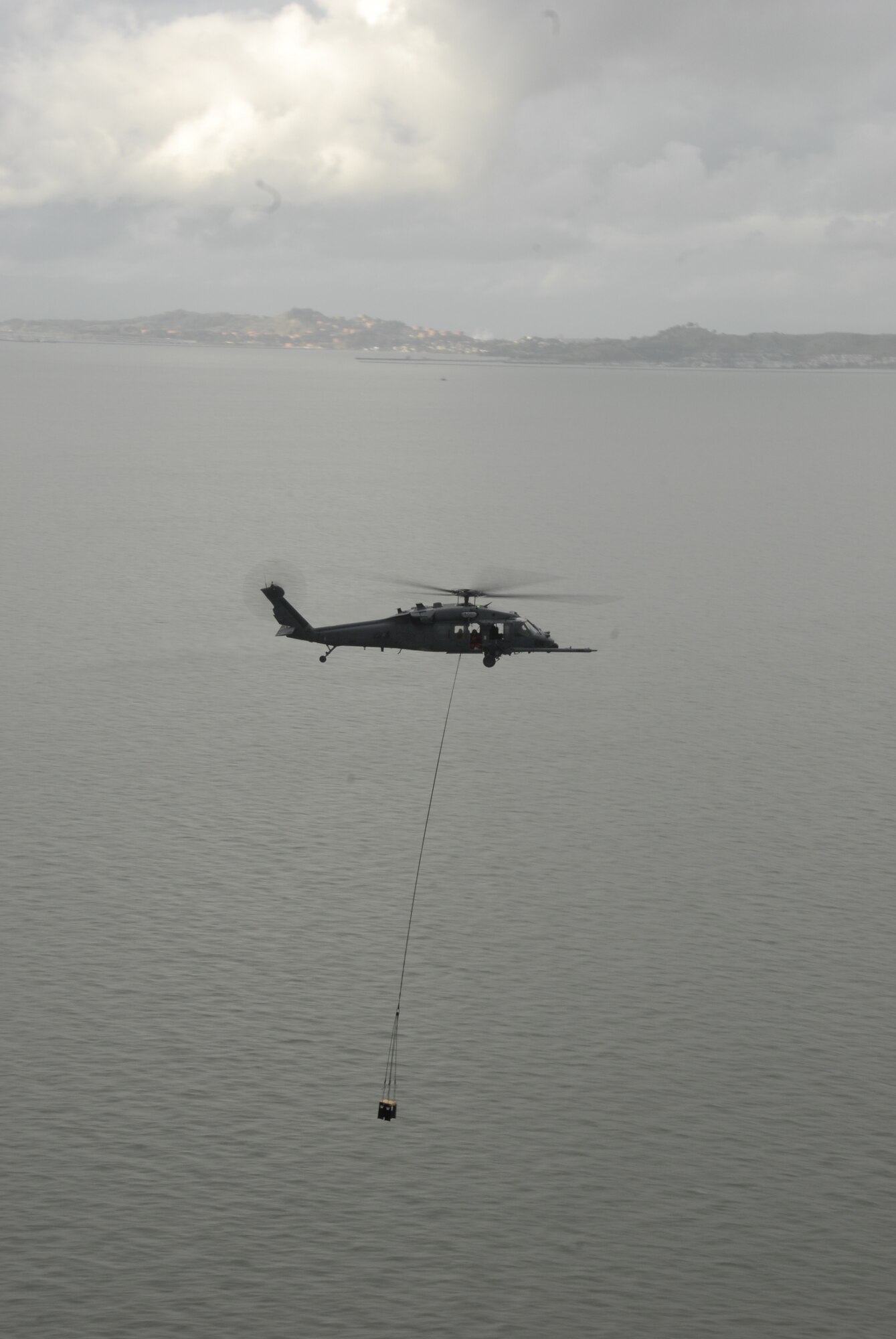 An HH-60G Pave Hawk from the 129th Rescue Wing at Moffett Federal Airfield,  transports 300 pound batteries with a sling load cargo net. The unit supported the U.S. Fish and Wildlife Service by transporting 48 new photovoltaic batteries to power a lighthouse and workshop at the Fish and Wildlife Service research facility in the Farallon National Wildlife Refuge Feb. 17. (U.S. Air Force photo by Tech Sgt. Ray Aquino)(RELEASED)