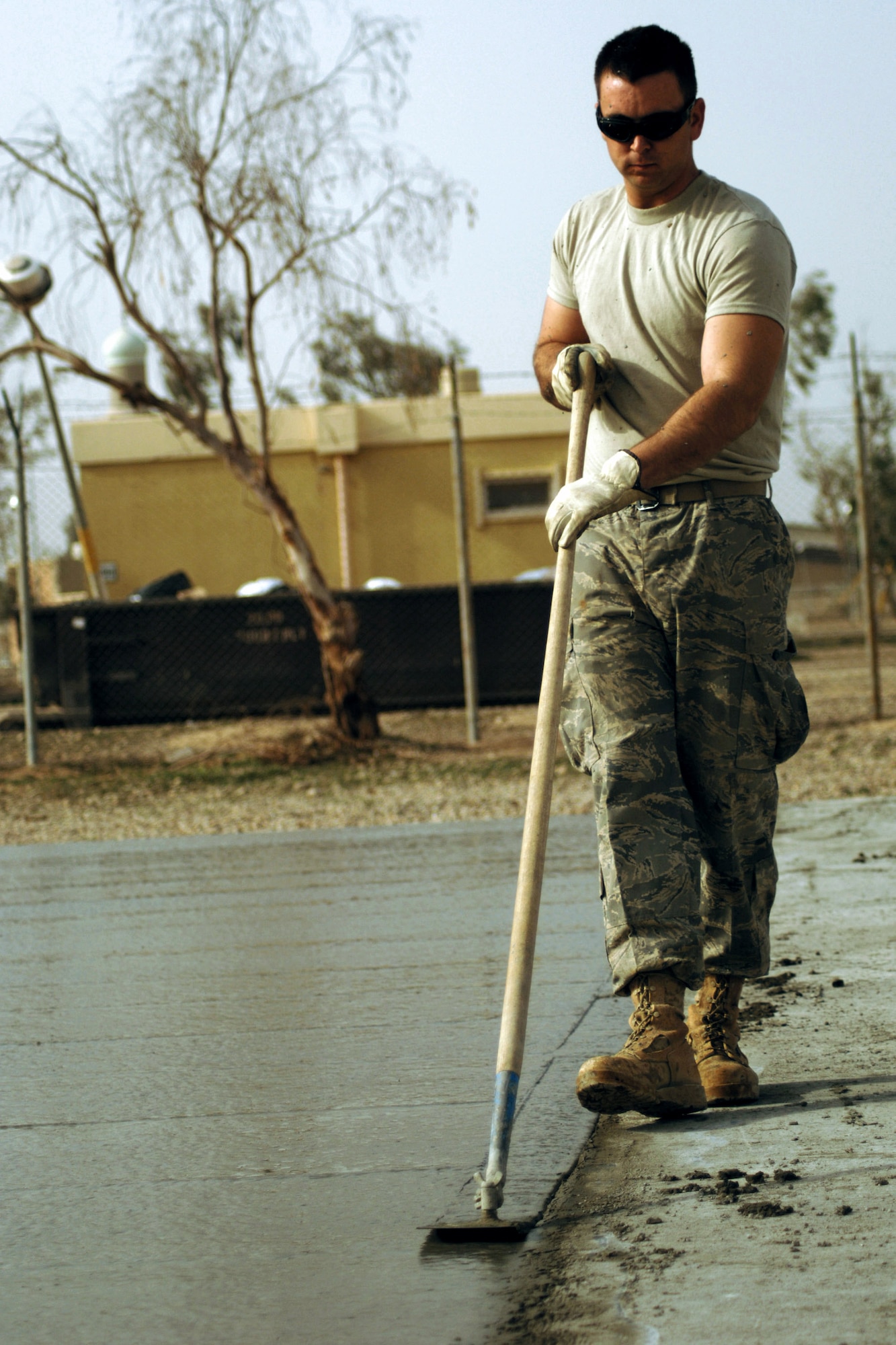 Airman 1st Class Daniel Bailey smoothes out the edge of a concrete pad Feb. 15 using a cement-finishing tool called a walking edger during a construction project at Joint Base Balad, Iraq. Airman Bailey, a pavement and construction equipment operator with the 332nd Expeditionary Civil Engineer Squadron, is deployed from Malmstrom Air Force Base, Mont. (U.S. Air Force photo/Staff Sgt. Dilia Ayala) 