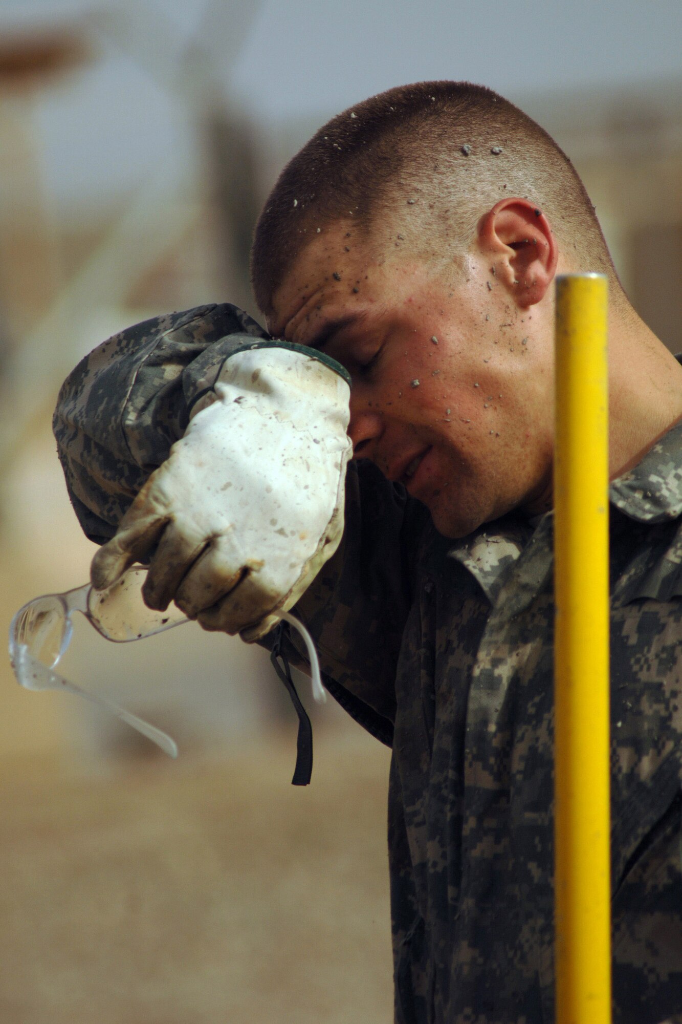 Senior Airman James Smith stops to wipe his brow after helping lay more than 35 meters of concrete Feb. 15 during a construction project at Joint Base Balad, Iraq. Airman Smith, a native of Geneva. N.Y., is construction equipment operator with the 332nd Expeditionary Civil Engineer Squadron and is deployed from Elmendorf Air Force Base, Alaska.  (U.S. Air Force photo/Staff Sgt. Dilia Ayala)
