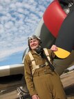 1/15/2009 - Standing next to a P-47 Fighter and wearing his flight suit from WWII, Sherrill Arvin poses for a photo so his family will have a record of the aircraft he trained pilots in. (USAF photo by Fernando Cortez)