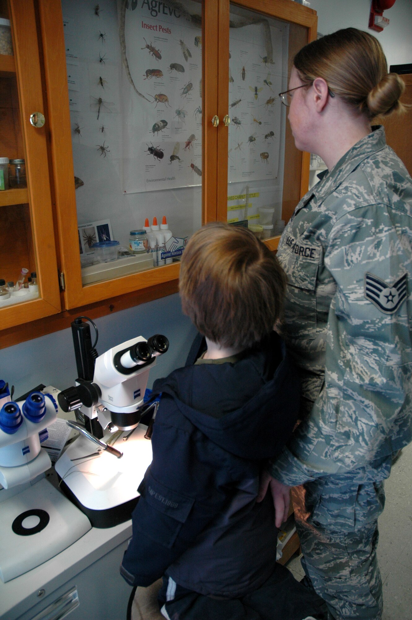 Staff Sgt. Laurie Kidwell, 341st Medical Operations Squadron, NCO in charge of public health, and her son, David look at specimens of spiders at the 341st Civil Engineer Squadron entomology office Feb. 17. The family will be leaving for Wright-Patterson Air Force Base, Ohio, soon on a humanitarian reassignment so the four-and-a-half year old can receive further treatment for Autsim. (U.S. Air Force photo/Senior Airman Dillon White)