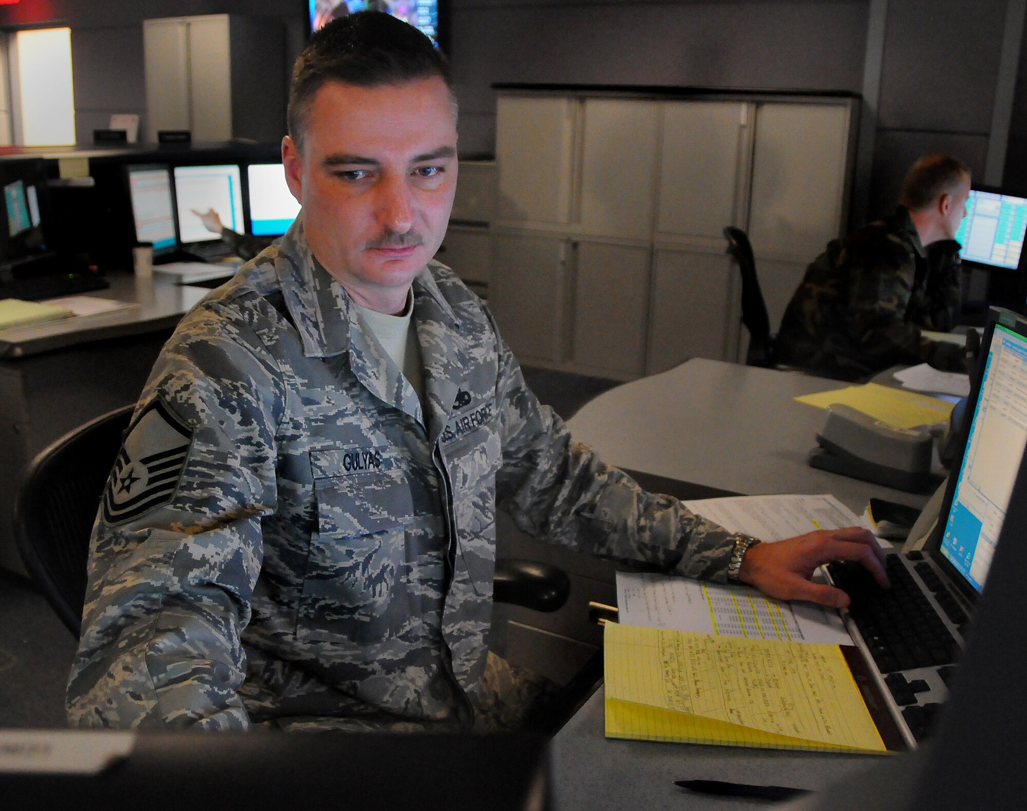 SCOTT AIR FORCE BASE, Ill. -- Master Sgt. George Gulyas, an aircraft maintenance craftsman assigned to the 618th Tanker Airlift Control Center, reviews information about on-going maintenance to a mobility aircraft from his position on the 618th TACC Operations Floor. As part of the Logistics Support Division of the 618th TACC's Command and Control Directorate, Sergeant Gulyas is responsible for coordinating maintenance support for AMC aircraft worldwide. (Department of Defense photo/Mr. Robert Fehringer)