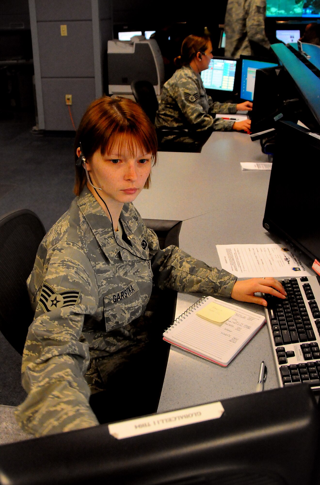 SCOTT AIR FORCE BASE, Ill. -- Staff Sgt. Kristyn Garstka, a Command Post controller assigned to the 618th Tanker Airlift Control Center, assists an Air Mobility Command aircrew via telephone from the 618th TACC Operations Floor. 618th TACC Command Post controllers are available 24-hours-a-day and engage in a combined 37,000 phone calls each month to assist AMC aircrews worldwide.  (Department of Defense photo/Mr. Robert Fehringer)