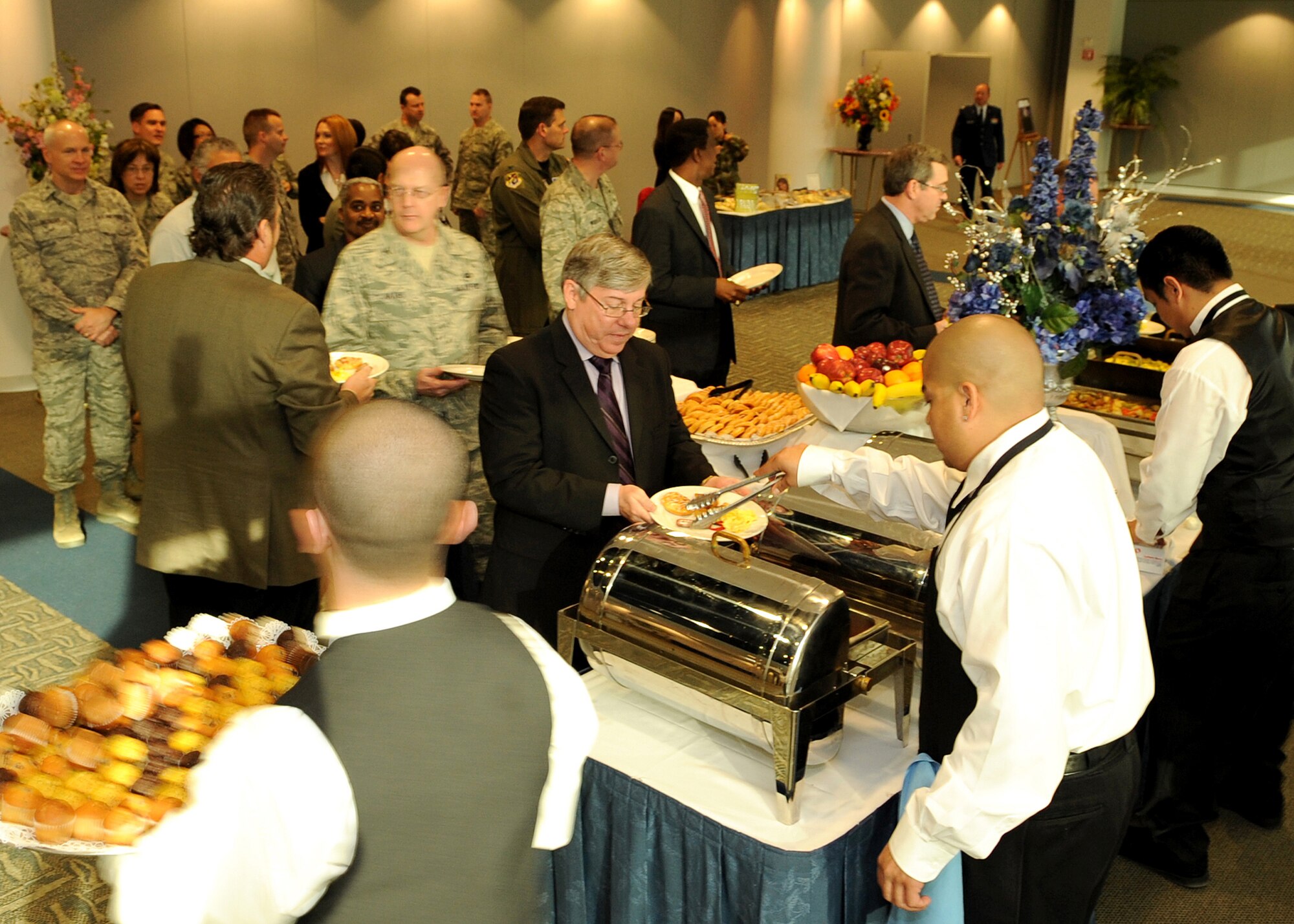Mr. John Wagner (center, with plate), Launch and Range Systems Wing chief technical director, is served by a staff member of the Club during the 2009 National Prayer Breakfast held at the Gordon Conference Center, Los Angeles AFB, Feb. 11. Mr. Wagner was one of the honored guests. (Photo by Stephen Schester)