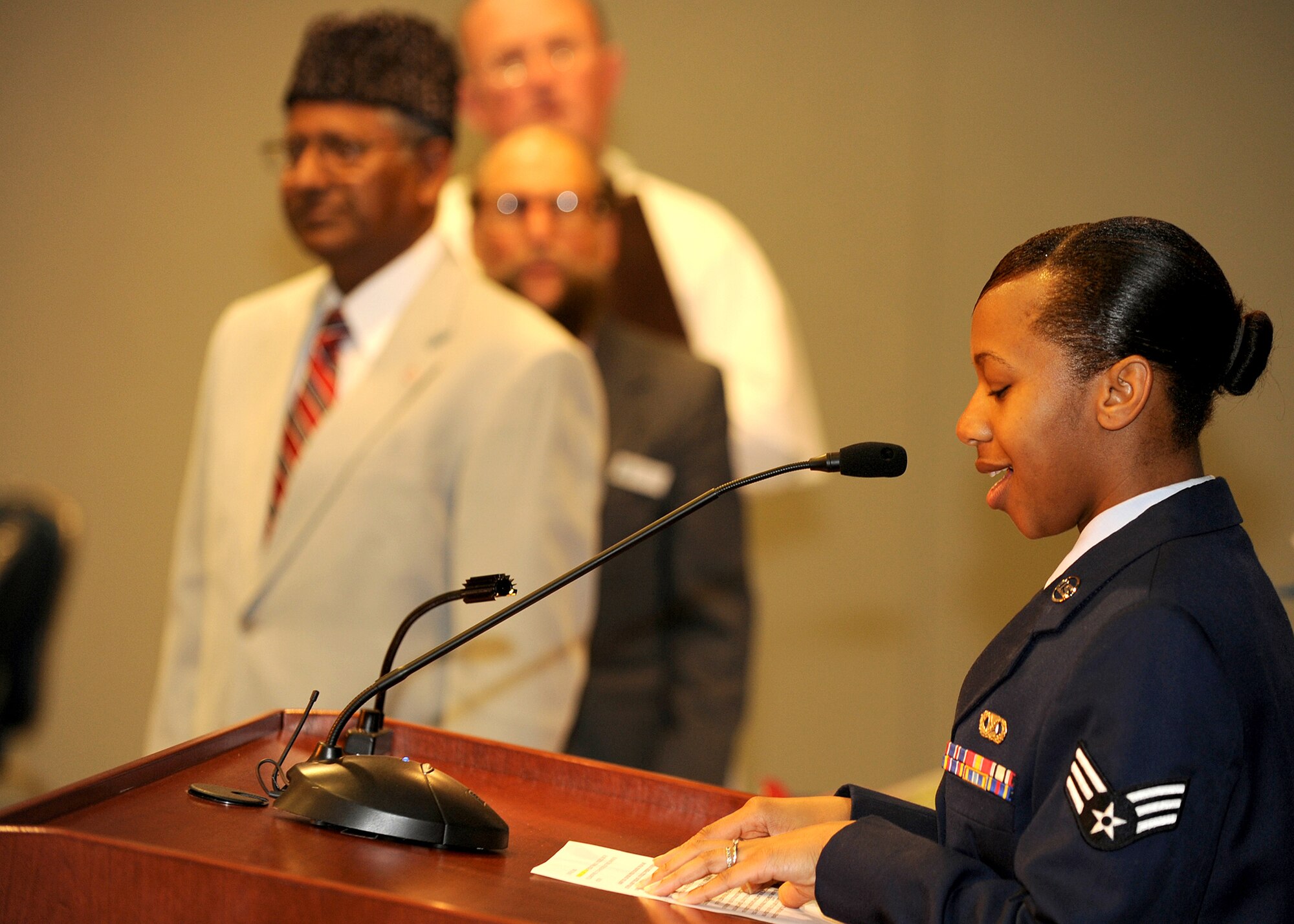 Airman Tracy Sims from the Chaplain’s Office reads the “Prayer for Our Troops” on behalf of the Protestant faith as representatives from other faiths wait to read their prayers. The 2009 National Prayer Breakfast was held at the Gordon Conference Center, Los Angeles AFB, Feb. 11. (Photo by Stephen Schester)