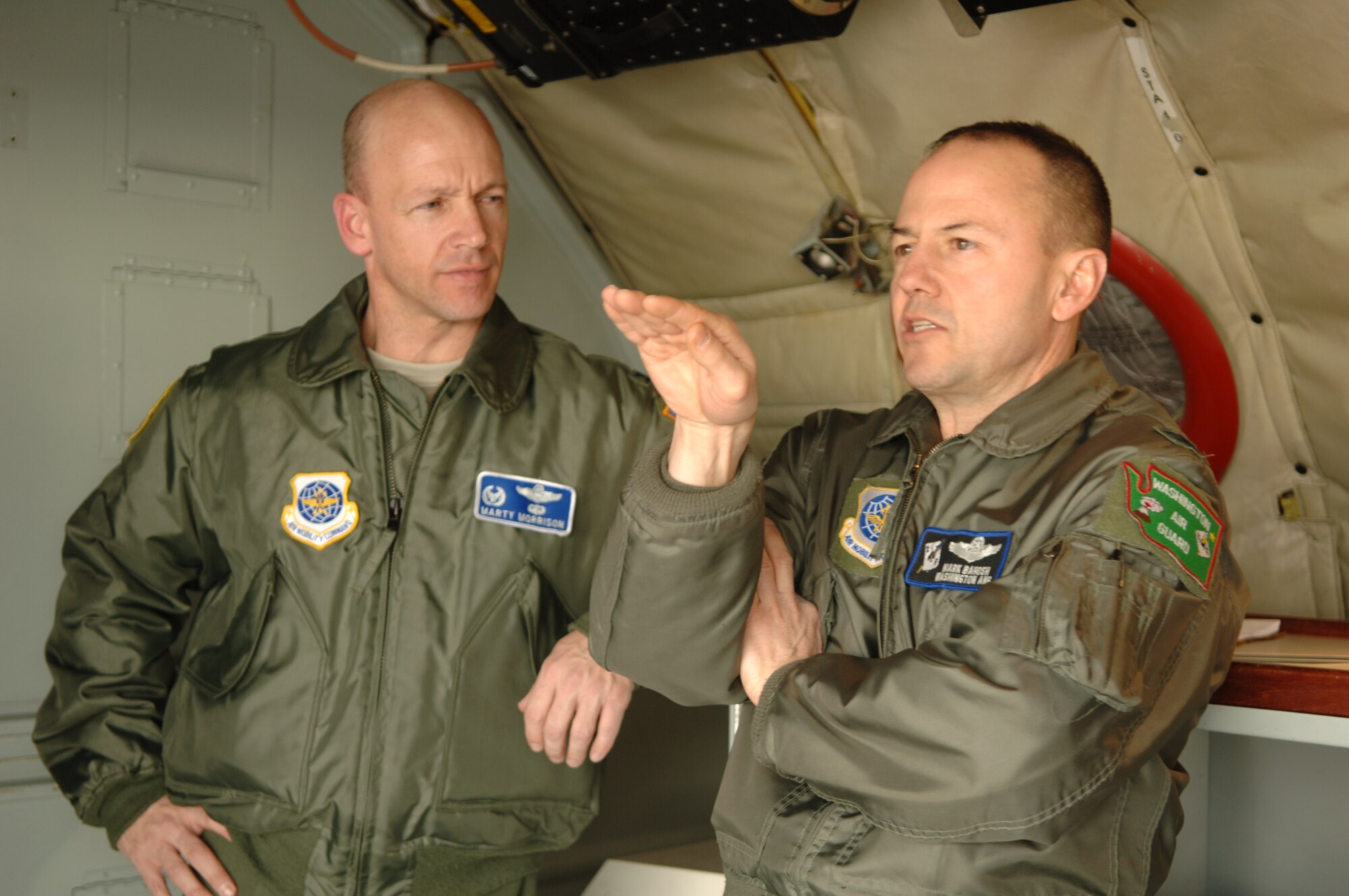 Col. Marshall Morrison, 92nd Operations Group commander listens as Col. Mark Bahosh, 141st Operations Group commander, discusses with much animation aspects of the KC-135 after landing in Cheyenne, Wyo. Feb. 17. Members from both the 92nd and the 141st flew to the 153rd Wyoming Air National Guard base in Cheyenne to “give Team Fairchild leadership a look at another associate unit, take away and build on their successes, and give us an opportunity to learn from their challenges as we forge the first ever Classic active duty-air national guard associate wing here,” said Chief Master Sgt. David Nordel, 92nd Air Refueling Wing command chief. (U.S. Air Force photo / Senior Airman Jocelyn A. Ford)
