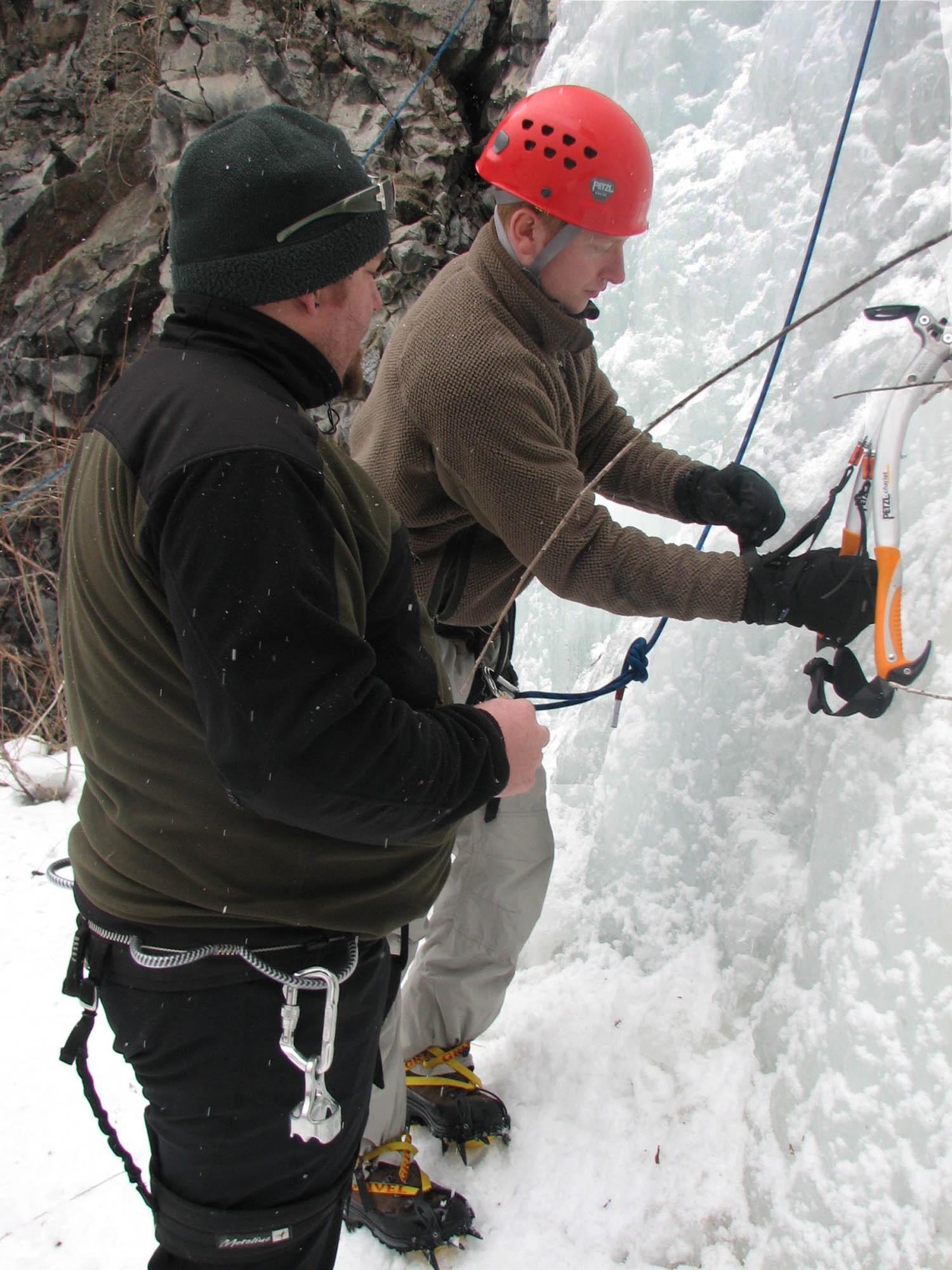 Ryan Murphy, Outdoor Recreation Connection staff member, provides Willie Golden, 22nd Training Squadron survival, evasion, resistance and escape specialist and a participant in the Outdoor Recreation Connection ice climbing trip, with a few pointers before he ascends a vertical frozen sheet of ice during a Valentine’s Day ORC ice climbing trip. (U.S. Air Force Photo / Senior Airman Kali L. Gradishar)