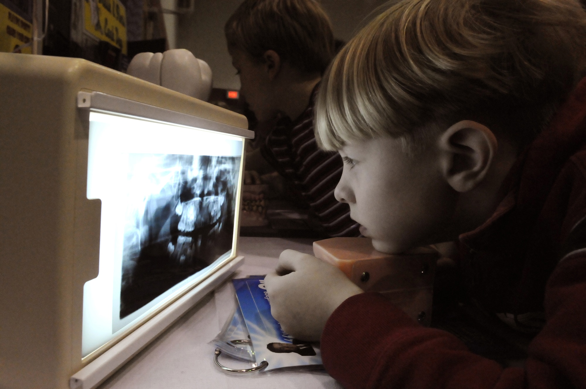 Colby Robertson, 1st grade student at Robins Elementary, looks at some dental x-rays .Representatives from the 78th Dental Squadron visited the school Feb. 12 as part of National Children's Dental Health Month.U. S. Air Force photo by Sue Sapp