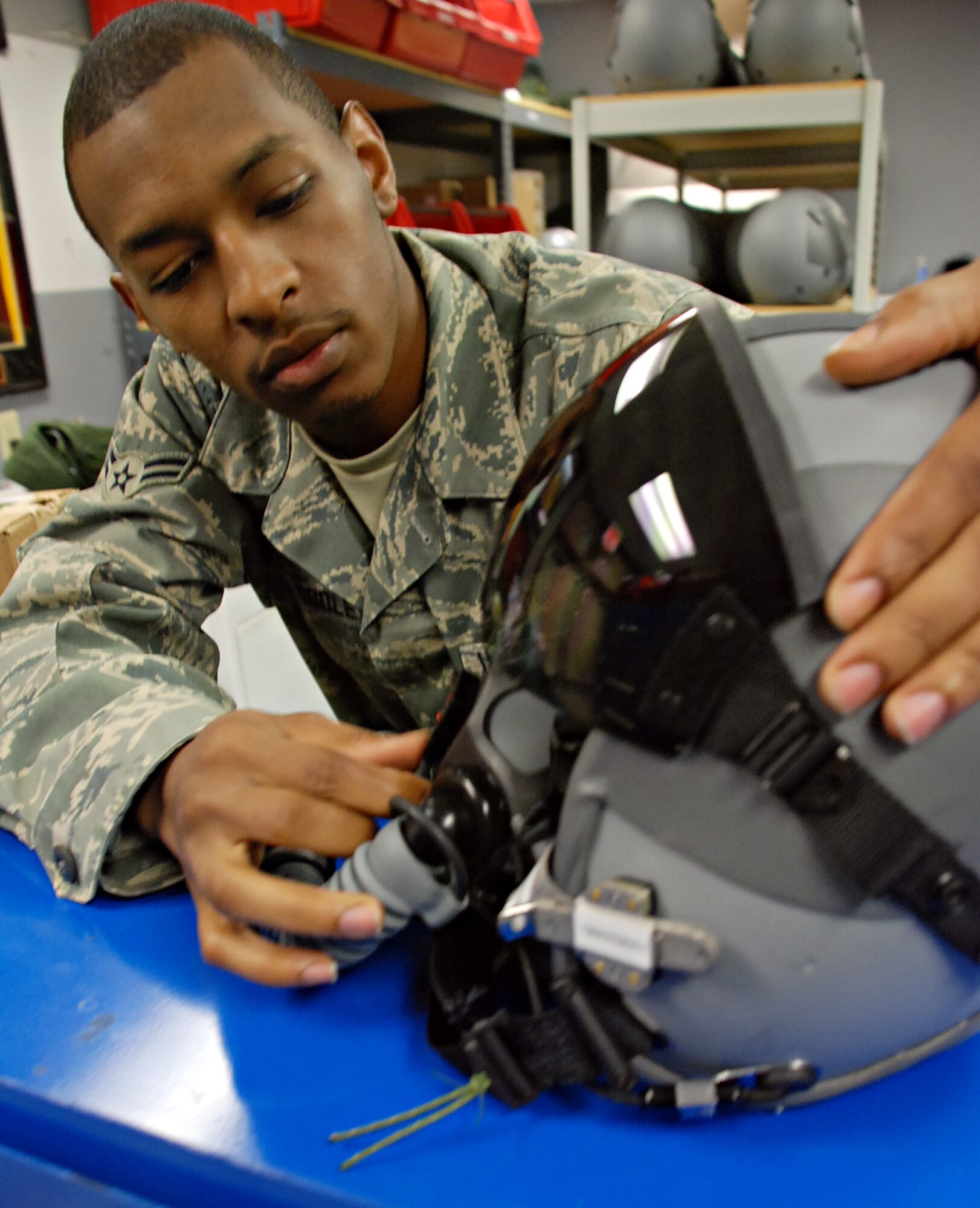 LAUGHLIN AIR FORCE BASE, Texas – Airman 1st Class Jarryd Dooley, Life Support technician with the 47th Operations Support Squadron, inspects a pilot’s helmet for any imperfections which may cause the helmet to malfunction during flight. Airman Dooley is a part of the life-support shop but works solely works in the helmet shop to inspect and maintain all helmets to keep them in good flying condition and fit students in their G-suits.  (U.S. Air Force photo by Airman 1st Class Sara Csurilla) 