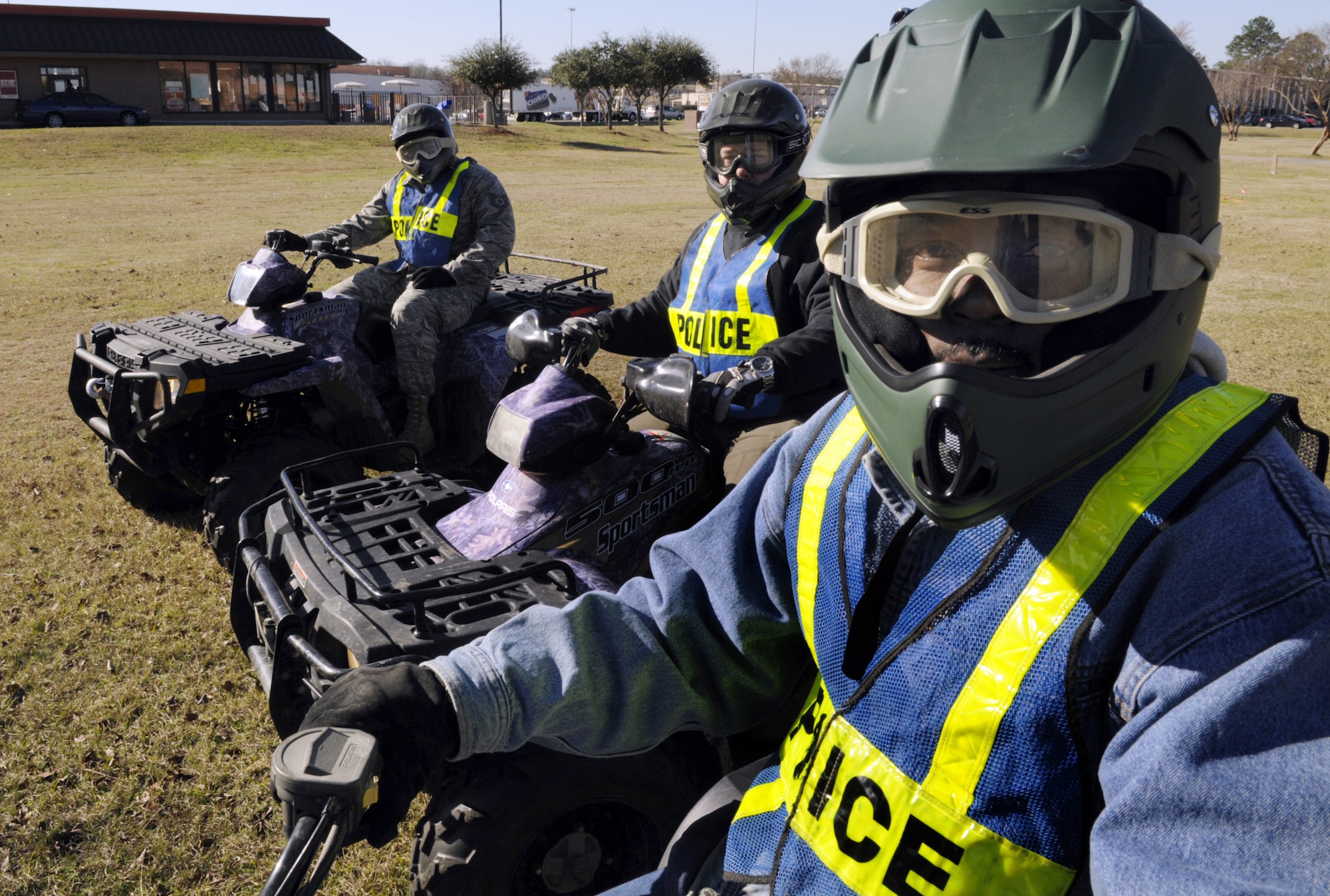 L-R, TSgt. Jessie Wells, 78th Security Forces, J.B. Toellner and Joe Greene, 78th ABW antiterrorism officers man all terrain vehicles to patrol the perimeter of the base. U. S. Air Force photo by Sue Sapp